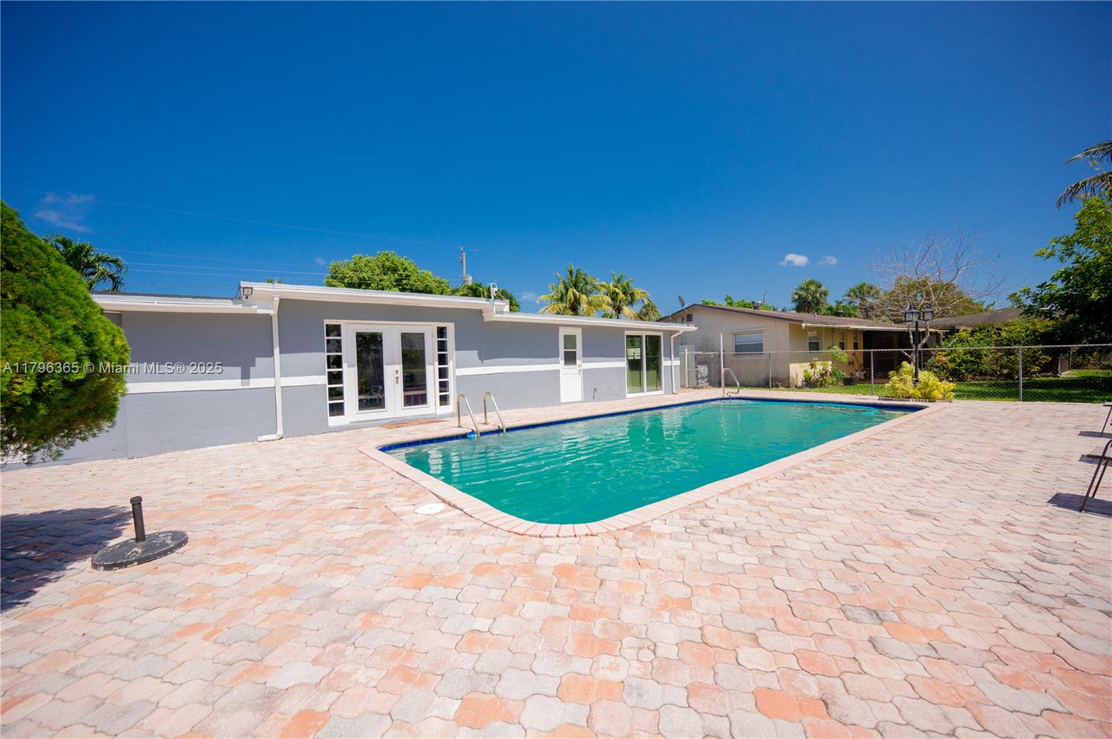 Welcome to this beautifully remodeled 4-bedroom, 3-bath home with a pool and big backyard—ideal for entertaining and enjoying the South Florida lifestyle. Located in a quiet no-HOA neighborhood, this home features a new roof, new AC, new water heater, new appliances, new water filtration system, updated electrical panel, and fresh paint inside and out. The primary suite offers a spacious en-suite bathroom with double sinks. Includes a security camera system. Enjoy a custom-built gazebo, lounge area by the pool, and peaceful canal views with no rear neighbors. Plenty of space for RVs, boats, and more. Close to parks, restaurants, and major highways.
