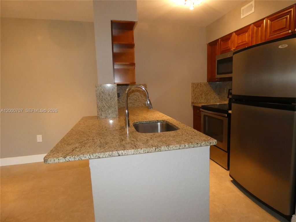 Photo of 2841 N Oakland Forest Dr #207, Oakland Park, FL 33309 (MLS # A12000707)