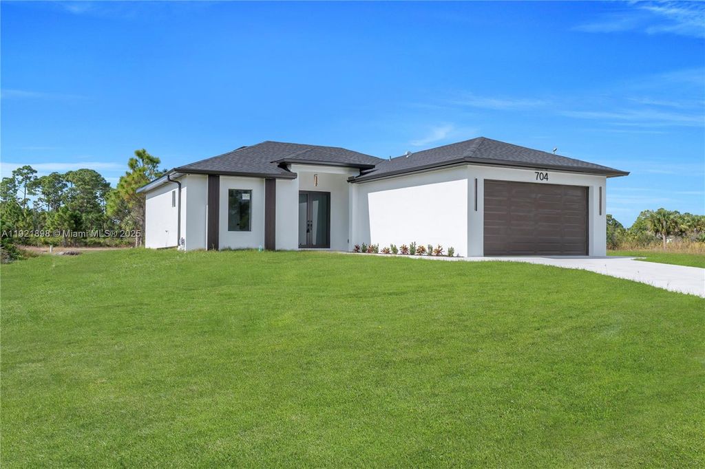 Photo of 704 Holmes Ave, Lehigh Acres, FL 33974 (MLS # A11921898)