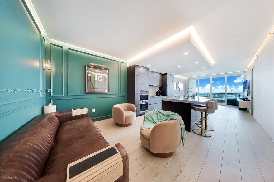 Must see. Designer-renovated 05 line with sweeping views of Biscayne Bay, Museum Park, PortMiami & the Miami Beach skyline. Spacious 1BD + Den with 2 full baths, 10’ ceilings and floor-to-ceiling impact glass opening to a large private balcony.

Upgrades include porcelain floors, custom millwork and feature walls, a modern chef’s kitchen with sleek cabinetry and waterfall-style island. Recessed + cove lighting throughout, and spa-inspired baths with floating vanities, backlit mirrors and frameless glass. Oversized primary bath features a dramatic wet-room shower with bench and rain shower.

900 Biscayne offers resort-style amenities including two pools, spa, fitness center, residents’ lounge/clubroom, movie theater, 24-hour security and valet. 1 assigned parking. Across from Kaseya Center, PAMM, Frost Science, and minutes from Brickell & Miami Beach.