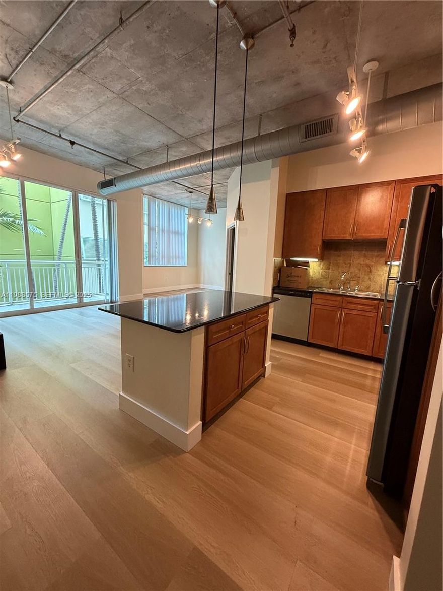 Beautiful 2BR/2BA loft-style condo at Cite on the Bay in Edgewater. Features concrete ceilings, brand-new vinyl flooring, brand new dryer, open kitchen with granite countertops and SS appliances, walk-in closet, in-unit laundry, and private balcony with courtyard views. Partially furnished with beds and nightstands. Enjoy resort-style amenities including pool, gym, 24/7 concierge, and garage parking. Prime location steps from Publix, restaurants, cafes, and across from Margaret Pace Park. Includes 1 assigned parking space, with a second space available for rent.