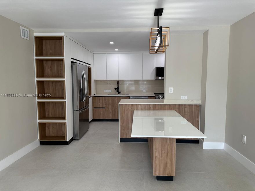 Fully Renovated in Prime Miami Beach. Located at Boston Plaza Condo—a meticulously renovated 2-beds, 2-baths + den, offering modern elegance just 2 blocks from the beach.  Modern Open-Concept Kitchen: Brand-new design featuring an integrated stone dining table, perfect for entertaining. Tailored storage solutions throughout, including in the den, ideal for a home office or guest space. New tile flooring, fresh paint, updated outlets and switches, and a brand-new central A/C unit ensure comfort and style. Building Amenities:  Rooftop Pool: Enjoy panoramic water views from the rooftop pool—a perfect spot to relax and unwind. Situated in the heart of Miami Beach's North Shore, with easy access to local shops, restaurants, and entertainment.