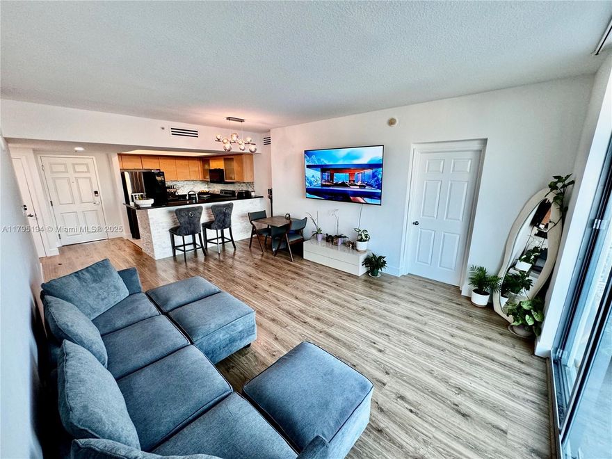 Experience luxury living in this spacious 2-bed, 2-bath condo with 1,195 sqft. This split floor plan unit with generous master suite with a Jacuzzi soaking tub, walk-in closet, and a beautifully designed layout. The open kitchen offers granite countertops, stainless steel appliances (refrigerator, microwave, dishwasher), and washer and dryer in-unit. Private balcony with stunning skyline views, sunrises, and even a far ocean view. This full-service building includes 24-hour concierge and security, an elegant lobby, TV lounge, a heated pool and hot tub, and a modern gym. The unit comes with one assigned garage parking space and is available furnished or unfurnished to suit your preference. Water and WiFi included. Steps from Young Circle, restaurants, shops, and just minutes to the beach.