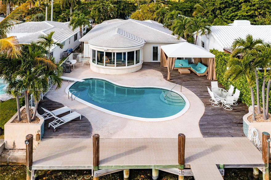 Rare opportunity to acquire Miami Beach home with unobstructed, panoramic wide bay view of Biscayne Bay, South Beach, Downtown Miami skyline, Port of Miami, and North Bay Road estates with coveted southern sunrise to sunset exposure. Permitted private, full service (electric and fresh water) dock with 30,000 pound boatlift. Ocean access, no fixed bridges. Large 8 ft depth pool with iconic diving board. Entry features double, LCD glass French doors with spectacular water view the moment you enter. Inviting, bright open floor plan with 9 ft ceilings, Impressive foyer, modern kitchen with wine cooler, quartz counters. 3 BR/3 BA plus flex room with closet, and laundry room. Sunroom, family room, dining room, Ipe deck, Cabana, and 2 car attached garage plus 6 car parking on circular driveway.