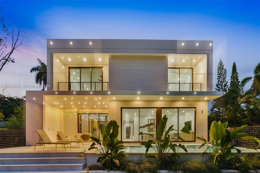 Architecturally refined single-family residence with completion scheduled for January 2026. Offering 4,300 SF of interior space, this thoughtfully designed home features 4 bedrooms, 5 bathrooms plus a powder room, service room, and an additional open flex-room with plumbing ready to convert into a full fifth bedroom with en suite bathroom. Designed in collaboration with an interior and yacht designer, the residence offers a highly functional floor plan with exceptional storage, clean modern lines, and beautifully curated natural light. The arrival experience is framed by a leather-finished travertine façade and a two-car garage. Seamless indoor–outdoor living connects the open layout to a summer kitchen, internal garden, pool, and sun-kissed south-facing outdoor area. A sculptural internal tree is intentionally showcased throughout the home, becoming a defining architectural focal point. The primary suite is a true retreat, featuring a spa-inspired bathroom with teak flooring in the shower and views toward a custom-designed private natural vertical garden wall, curated with plant selections chosen specifically for this space. High-end finishes, integrated systems, and generous storage complete this exceptional residence. Located in Keystone, a gated community just five minutes from Bal Harbour Shops and the beaches, this home offers privacy, convenience, and an elevated coastal lifestyle.