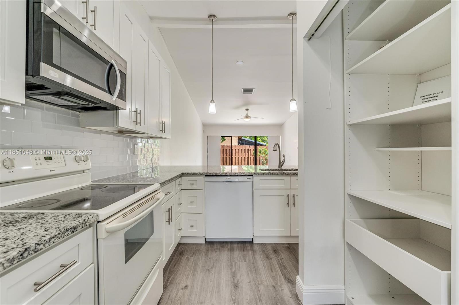 Welcome home to this beautifully villa in the heart of Plantation! This unit offers a combination of space & comfort. With an open layout, solid laminate waterproof floors, a fully renovated kitchen displaying 42” height wood wall cabinets, glass backsplash, granite countertops, soft-close drawer slides and a spacious pantry. Newer roof & rain gutters (Jul. 2023), 2.5 ton A/C with UV light and full duct replacement (Jan. 2021). Master bedroom updated in Mar. 2024 with an impact Vinyl sliding glass door with heavy reinforcement. The sliding glass doors lead out to a fenced courtyard across the lake with amazing views and lots of natural light! Conveniently located near Plantation Walk, parks, major shopping centers, hospital, dining, entertainment & more!
