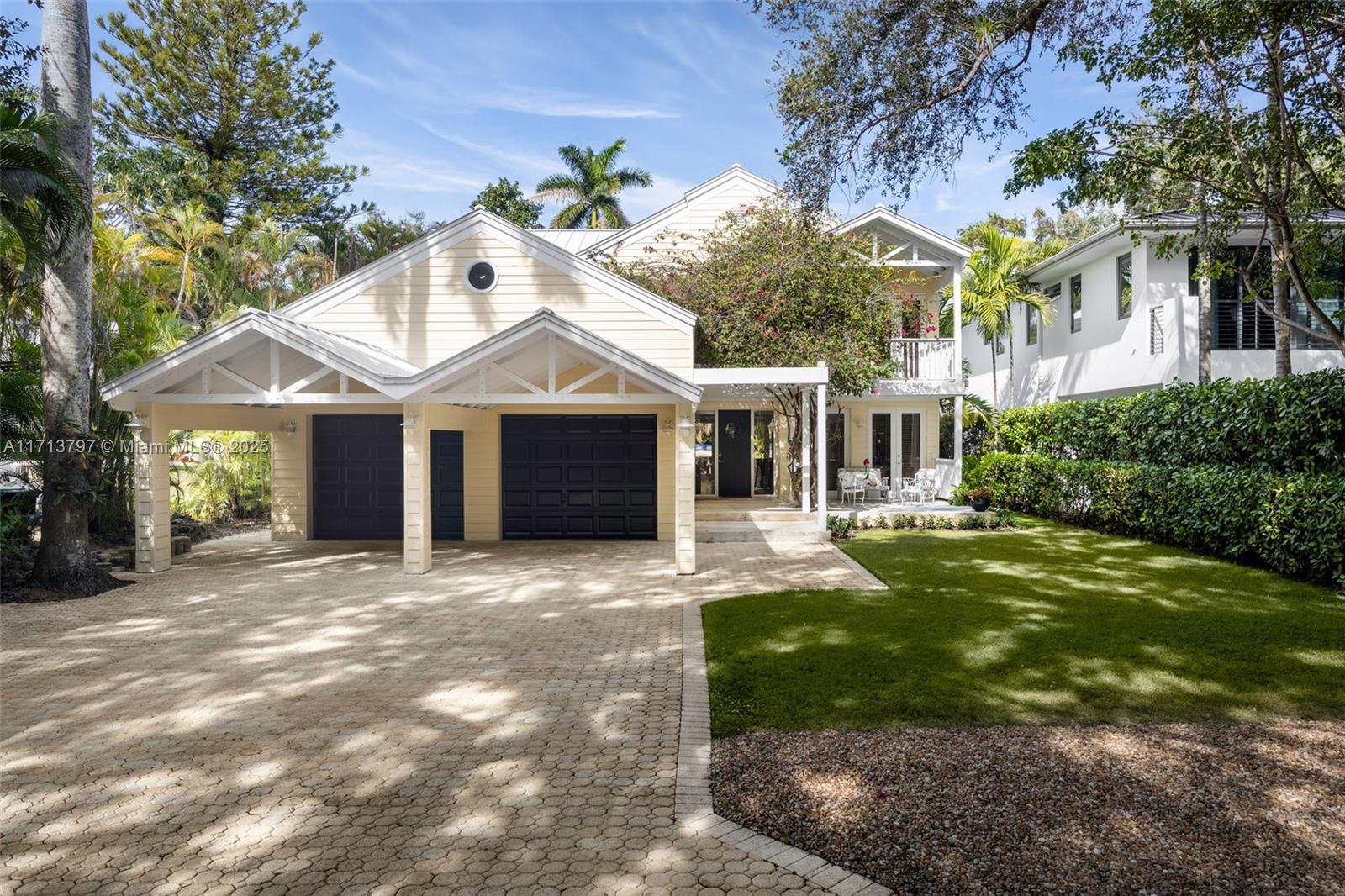 Captivating Key West style home on a coveted tree-canopied street in prestigious North Coconut Grove. Custom built w/ attention to detail and luxury fixtures & finishes throughout. Breathtaking, light-filled living spaces feature soaring, 29-foot+ vaulted, wood-beamed ceilings. Expansive eat-in kitchen & adjacent family room w/ banks of French doors opening to a deep covered terrace. Oversized primary suite is the ultimate retreat & offers private balcony with tree-top views. Experience year-round outdoor living & entertaining around the heated pool & sundeck surrounded by lush tropical landscaping. Situated high on a coastal coral rock ridge, one of the highest sea-level elevations in South Florida and close to the historic Grove village’s boutiques, cafes and bayfront parks & marinas.