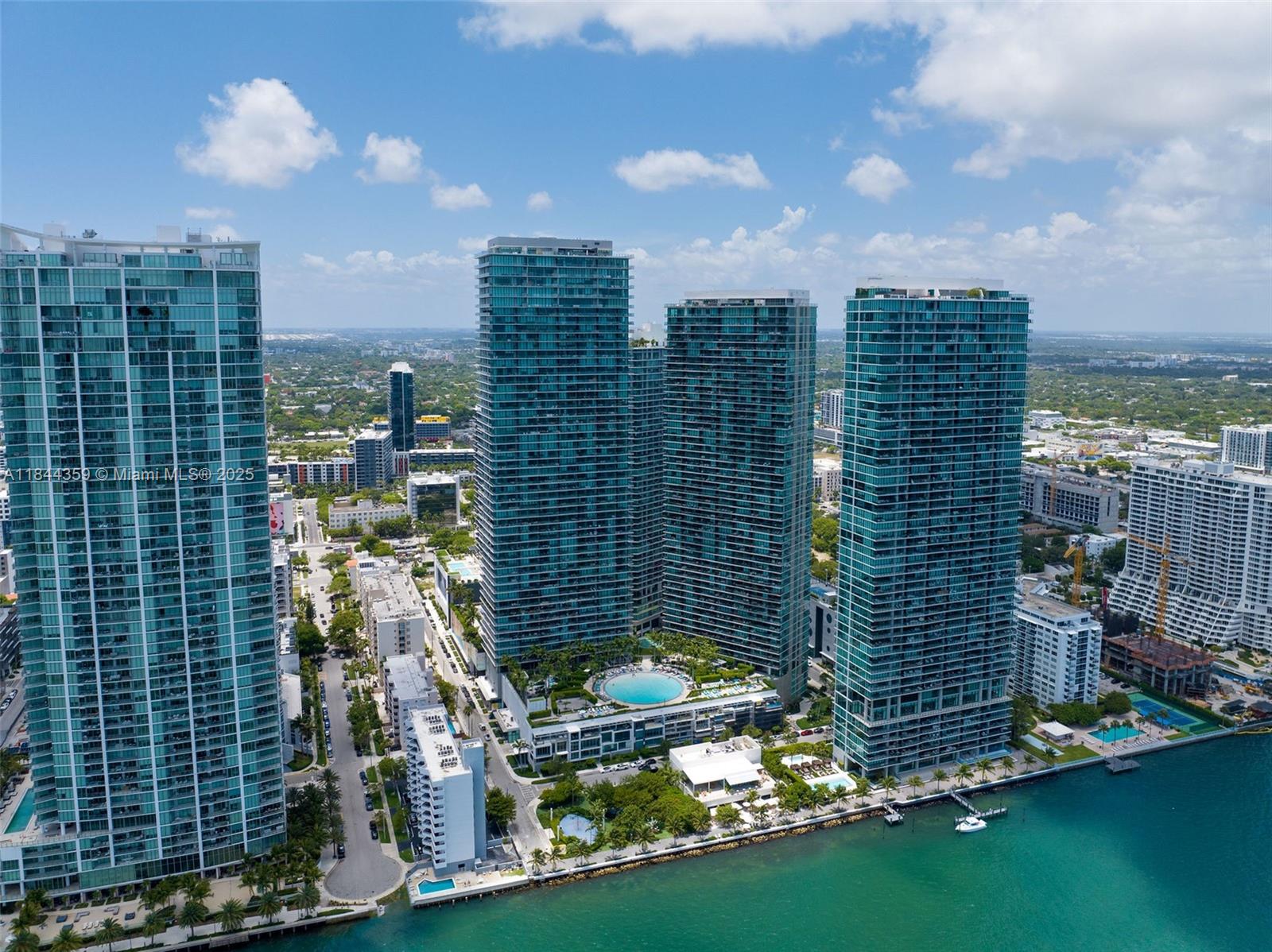Furnished Waterfront Lease Available Now! Panoramic Views at Paraiso Bay! Immaculate 1 bed / 1.5 bath with breathtaking direct water views. Move-in ready with updated porcelain floors, custom built-in cabinetry in the bedroom, Bosch appliances, high-end finishes, built-out closets, and blackout shades. Furniture is negotiable and in excellent condition. Enjoy resort-style amenities: world-class gym, spa, wine cellar, cigar lounge, theater, home cinema, bowling alley, two tennis courts, and a massive circular pool. Private gated community in Edgewater—minutes to Design District, Wynwood, Brickell, beaches, and top dining.