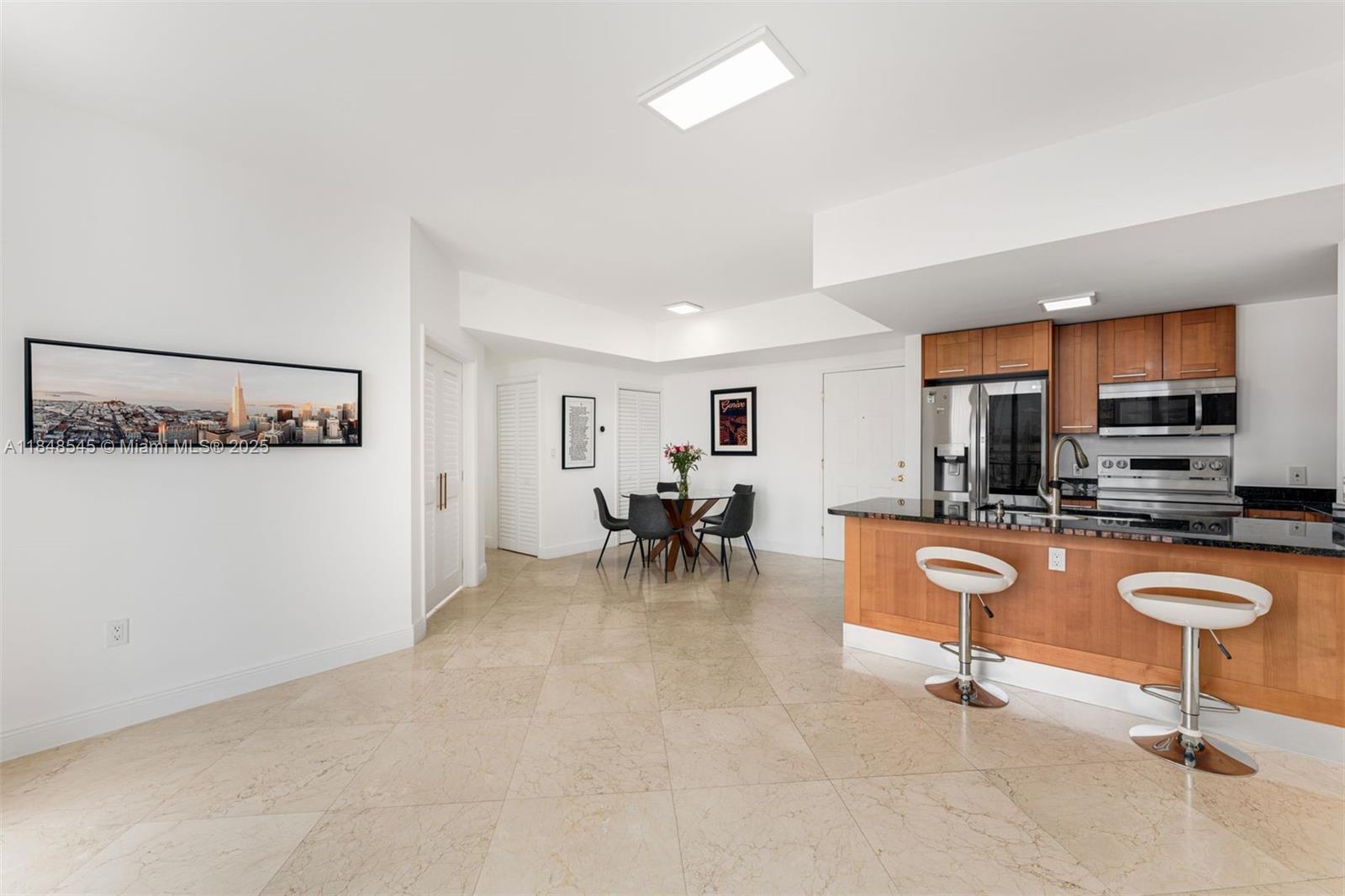 Exceptional value for this well-maintained 2 Bed + Den condo at One Village Place, steps from all that Merrick Park has to offer. Unit 601 offers a split floor plan with an abundance of natural light. The versatile den can be utilized as a home-office, entertainment area, converted into a third bedroom and more. Brand new fridge/freezer. Newer AC system. NEST thermostat for online control. Dual vanity primary bathroom. Window treatments throughout with upgraded lighting. One Village Place is a full-service building offering a fitness center, sun-soaked pool deck, front desk service and management on-site. TWO assigned parking spaces. Perfectly located close to the University of Miami, Metrorail, Downtown Coral Gables, Biltmore, and more. Walk to coffee, dining, shops, and dog grooming.