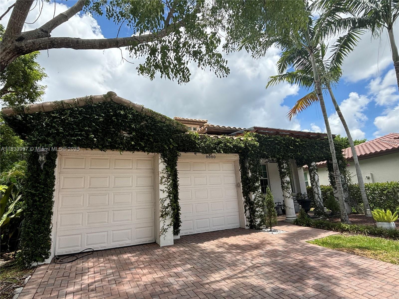 THE IVY HOUSE! Gorgeous 4 Bedroom 3 Bath Ready for all you and your Family's needs. This tropical home With updated front/back porches makes for a nice oasis. Tons of privacy in the exclusive, gated community of Heron Bay. features soaring 13-11 ft ceilings & chandeliers throughout. Open concept Kitchen/Living. SS appliances, double oven, 8-foot granite island. possible 5th bedroom. Master Bedroom features 13 ft ceilings and an en-suite bath. Walk-in shower, jacuzzi tub, his/hers sinks. Custom built-ins 2nd & 3rd bedrooms are both spacious w 13-11 ft ceilings. The 4th bedroom/3rd bath is a RARE & highly sought-after space. Separate from house makes a Perfect Office/In-Law Suite! Private, fenced-in yard surrounded by gorgeous palms & banana trees.