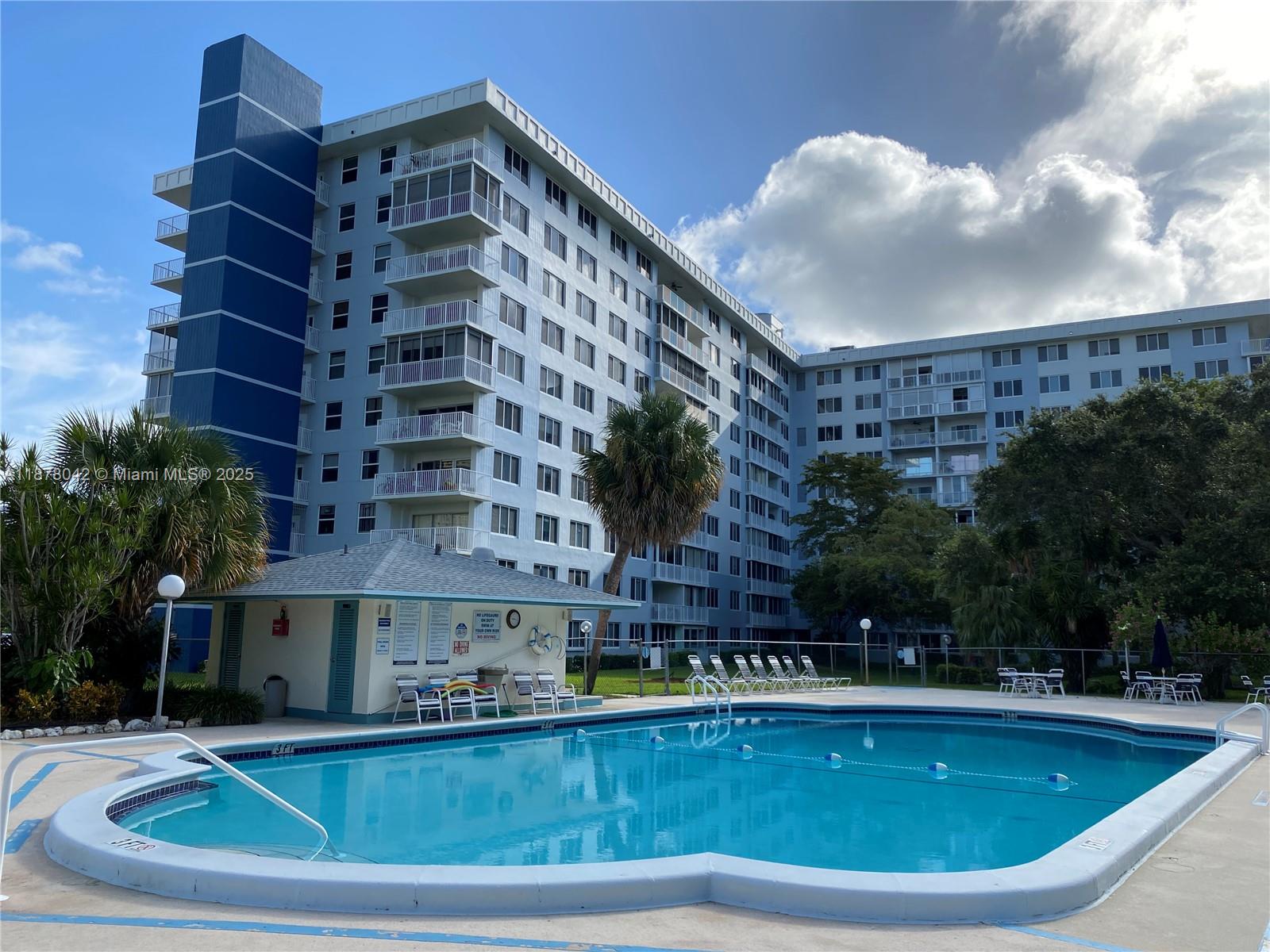 Welcome to this beautifully maintained 2-bed, 2-bath condo at Hillcrest, located in the heart of Hollywood. This light-filled unit offers an open living and dining area, a well-appointed kitchen, and an enclosed balcony perfect for enjoying the South Florida lifestyle. Spacious primary suite featuring generous closet space and an en-suite bath. The second bedroom is ideal for guests, a home office, or additional family space. Wine cooler in the kitchen, impact windows and enclosed balcony overlooking the park and the pool. Water, basic cable and internet included in rent. Secure 7-11 concierge. Enjoy the park walking trail, clubhouse w/kitchen, flat screen TVs & BBQ area plus tennis and pickleball courts. Excellent location near all, 15 min to the beach. You'll love this lovely condo!