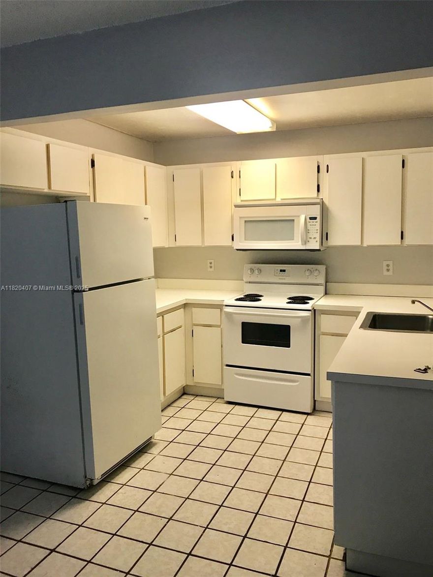 Great opportunity to invest! Great, cozy, aptly distributed, nicely kept, 2 split bedrooms/2 bathrooms, corner unit with accordion hurricane shutters at Banyan Tree. Conveniently situated in the popular and well-established community of "The Hammocks" where amenities include jogging and bike paths, tennis courts, picnic areas, child play areas, community pools, gym and beyond. Also located within walking distance to schools, parks and more. Tenants occupied until 07/31/2025 price of rent 2,200/month. **Unit is part of a bulk condo sales portfolio