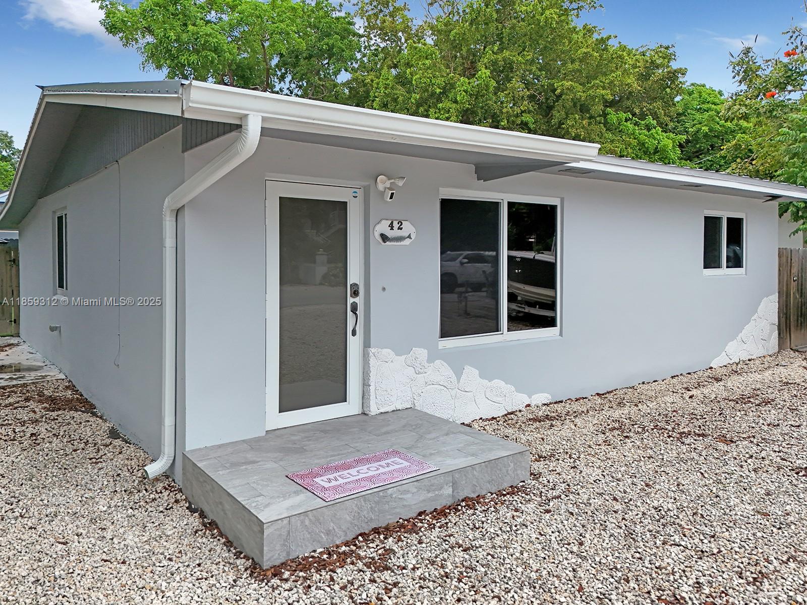Welcome to Paradise! Annual Lease! This is a 2/1 property with an extra den space, plus a 1 bedroom back house that can be rented together with the main home for additional per month. Located on MM 103.5 on the ocean side of Key Largo with close proximity to Miami, this property has everything you need to enjoy the Florida Keys! Highlights include: in-unit laundry, a fortress for storms, CBS home equipped with an aluminum roof, fully remodeled, & enough parking for boat/trailer, golf cart & guest parking. The backyard oasis features a 10+ person jacuzzi & swim spa, outdoor kitchen, and lounging area. Optional access to Largo Sound Park includes private bathrooms, trailer parking, private beach, & a private boat ramp with easy ocean access.