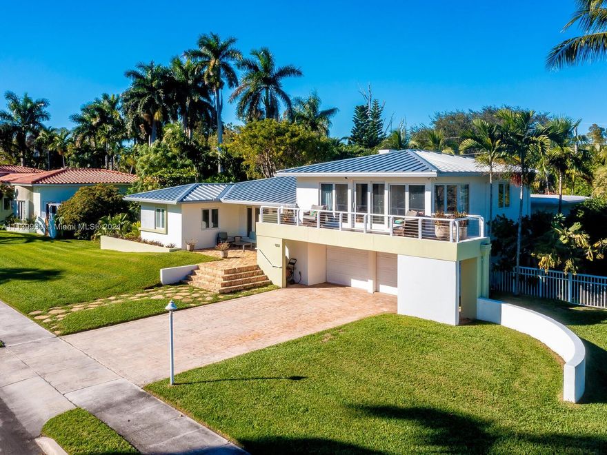 PARK YOUR YACHT(CAPACITY FOR THREE 40 FOOT BOATS) IN FRONT OF YOUR UPDATED MID CENTURY MODERN HOME.  150' LINEAR FEET OF WATERFRONT ON PROTECTED CANAL, EASY ACCESS TO THE OPEN OCEAN.27,000+ SQ FT LOT.  TROPICAL GARDENS LOCATED IN THE MIDDLE OF A BIRD SANCTUARY.  LARGE POOL, GIANT COVERED OUTDOOR SPACE WITH PATIO BAR.  4 BEDROOMS AND 4 FULL BATHS, MASTER BEDROOM IS UPSTAIRS WITH A SITTING AREA OVERLOOKING THE CANAL AND VIEWS OF THE OPEN BAY. MASTER BALCONY.  OPEN FLOOR PLAN, PERFECT FOR ENTERTAINING.  COOKS KITCHEN, INSIDE LAUNDRY ROOM, ATTACHED GARAGE WITH HALF BATH.  2020 NEW ROOF AND AC.  ALL IMPACT WINDOWS AND DOORS. SEAWALL DOCK AREA WITH 50 AMP ELECTRICAL FOR 3 BOATS AND DOCK WATER.