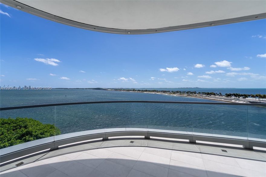 Experience elevated waterfront living at Una Residences. This exceptional 3 Beds/3.5 Baths residence offers breathtaking, unobstructed views of Biscayne Bay and the Atlantic Ocean with dramatic floor-to-ceiling windows in the living area, filling the home with natural light and showcasing spectacular sunrise vistas.Thoughtfully conceived with refined elegance, the residence is adorned with prime natural wood throughout the living areas, creating an atmosphere of warmth, texture, and timeless organic sophistication. The primary bath is appointed with luxurious Calacatta finishes, including a striking Calacatta mosaic floor in the shower. The powder room features sophisticated Vanilish Pear flooring, while the secondary bathrooms are finished with exquisite Bianco Neve mosaic floors. The gourmet kitchen is equipped with premium Gaggenau appliances seamlessly blending performance and cutting-edge design.Developed by OKO Group, led by Vlad Doronin, in collaboration with world-renowned architects Adrian Smith and Gordon Gill, and masterfully landscaped by Enzo Enea, Una Residences sets a new benchmark for boutique luxury living.Residents enjoy an exceptional suite of resort-style amenities, including three swimming pools, a full-service spa, state-of-the-art fitness center, private screening room, and a children’s playground—thoughtfully designed to provide both relaxation and recreation in a serene bayfront setting.