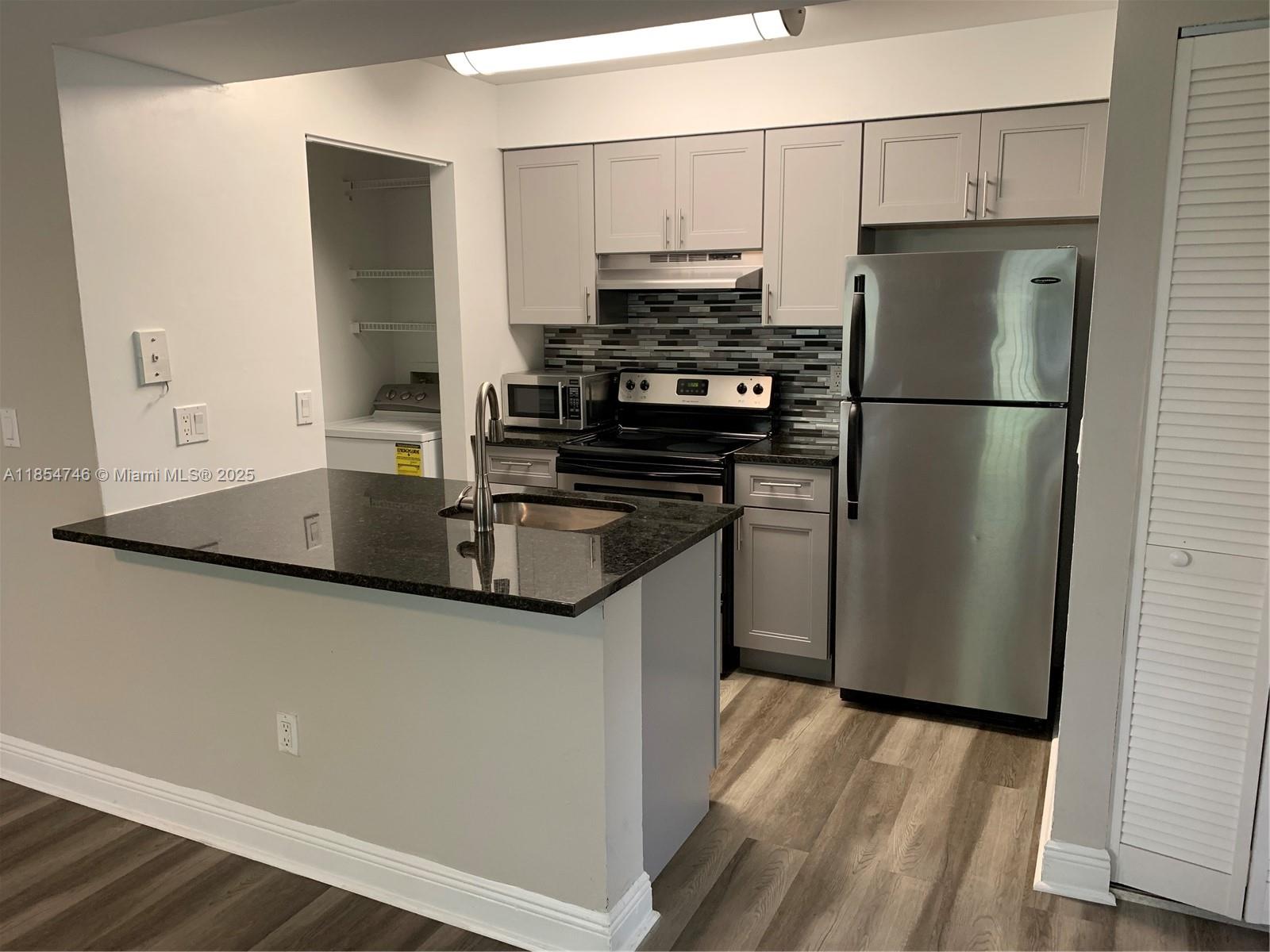 Beautiful upgraded modern 1 bedroom/one bathroom condo in luxury gated community. New kitchen and bathroom, black granite countertops and stainless steel appliances. Washer and dryer in unit. Fantastic view of lake from private balcony.