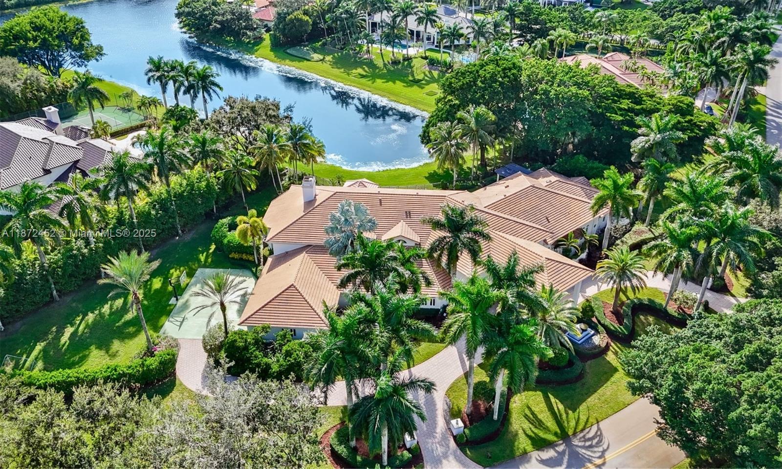 Experience refined lakefront luxury in the prestigious gated community of Windmill Ranch Estates. This meticulously updated estate spans 7,647 SF (10,587 adj. SF) on a 1.5-acre lot, showcasing breathtaking water views and unparalleled privacy. This extraordinary estate features 6 BD, 8.5 BA, office, custom home theater, & billiard room with bar. Soaring 20-ft ceilings and expansive windows fill the open layout with natural light. The gourmet kitchen is equipped with top-tier appliances, 3 Infinity Pro Wine Cooler, and a double-sided fireplace. Outside, enjoy your private resort-style oasis with a lake view pool with new water fixtures, swim-up bar, sunken gazebo, and a fully equipped summer kitchen, all overlooking serene lake views. Additional upgrades include 2021 roof, 4 new A/C units