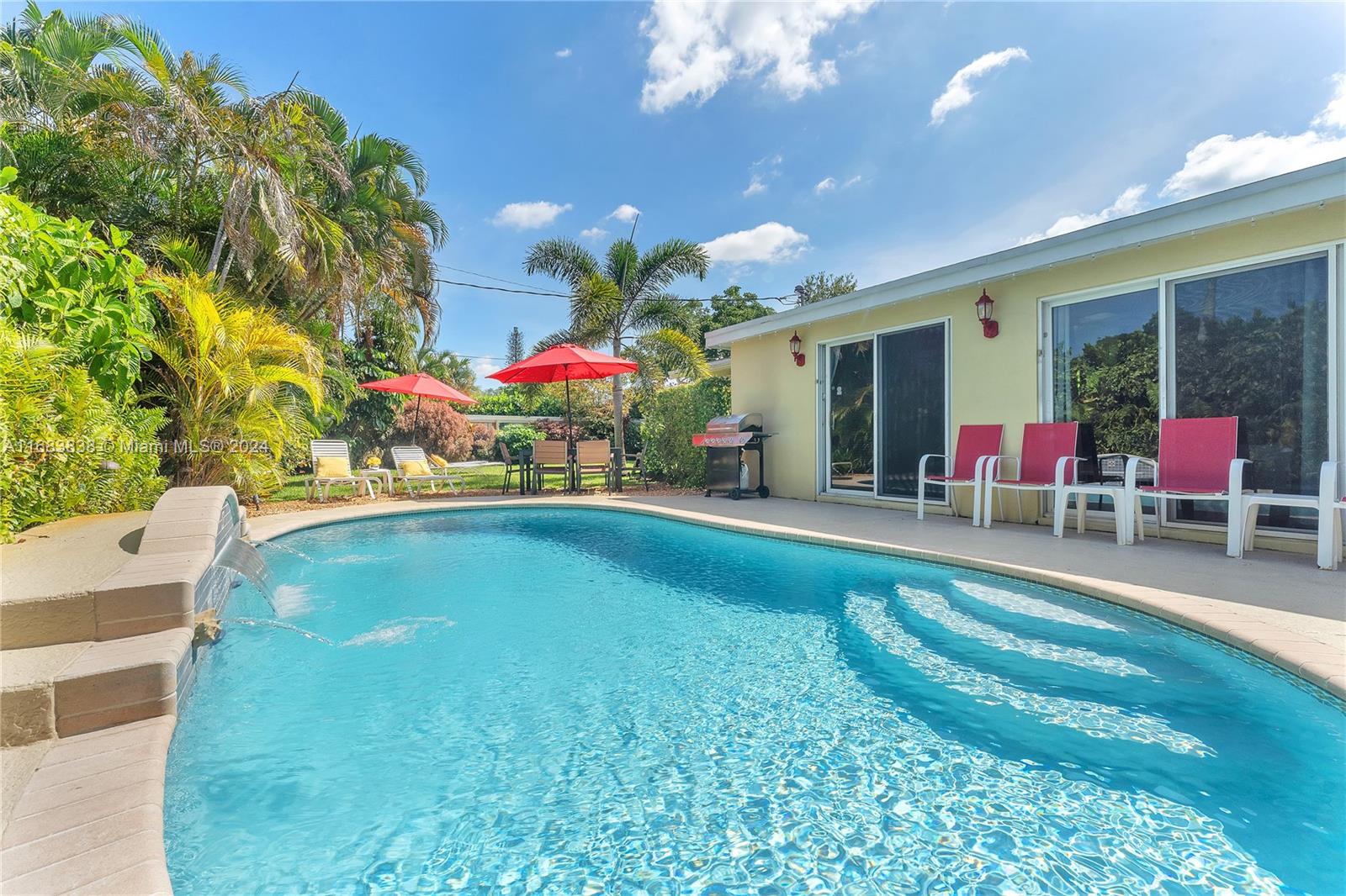 Beautiful 4-bedroom, 2-bathroom pool home in the heart of Wilton Manors! This spacious property boasts an open floorplan with abundant natural light streaming through large windows, creating a bright and airy ambiance. Set on an expansive 10,000+ sq ft corner lot, the fully fenced backyard offers resort-style living with a heated saltwater pool featuring a waterfall and landscaping lights. New Roof, updated kitchen and baths, interior laundry room, impact windows in the Florida Room, and shutters for other windows add modern touches. A new sprinkler well pump is also included, and the home is being sold fully furnished. Currently holding an active vacation rental license, this property is ideally located near downtown Fort Lauderdale and the beaches.