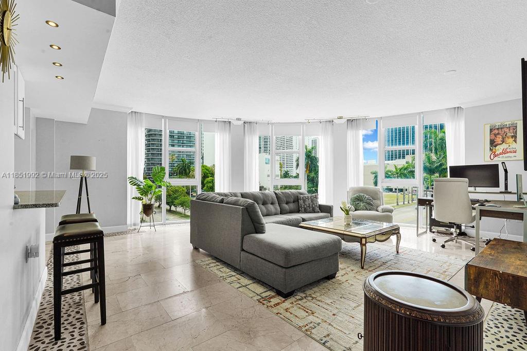 1 Bedroom + DEN. Oversized corner unit in Edgewater. This bright 1 bed, 1 bath features a converted den perfect as a second bedroom or office. Floor to ceiling windows, high ceilings, crown molding, and a modern kitchen with stainless steel appliances create a spacious feel. Enjoy city views from your private balcony. Parking is steps from your door no elevator needed. No direct neighbors on your floor for added privacy. 1800 Biscayne Plaza offers 24-hour security,a fitness center, and a brand-new pool. Walk to Publix, Margaret Pace Park, Wynwood, and the Design District. Buy with as little as 5% down perfect for end users or investors! Short-term rentals allowed (30-day minimum)