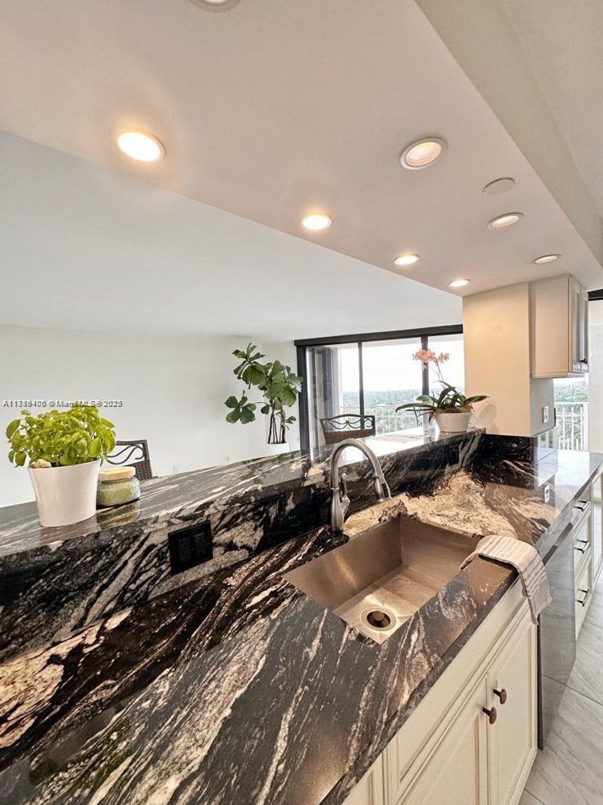 ADDED VALUE, ASSESSMENT PAID IN FULL BY SELLER. 2 PARKING SPACES. This Tower 4, 2/2 unit overlooks Quayside Marina. The kitchen is designed for entertaining, allowing you to enjoy the company of your guests while preparing meals. The unit features neutral imported Italian tile and custom kitchen and bathroom designs. Once you enter the property, you'll feel a sense of security and tranquility—a safe and secure environment offering tennis, pickleball, a marina, a playground, and two restaurants. You can work out and enjoy breakfast or lunch while waiting for friends. Treat yourself to the best coffee and freshly baked croissants, or enjoy waterfront dining with a view of the marina.  Don't miss the opportunity to live the Miami lifestyle. See Broker remarks for further information.