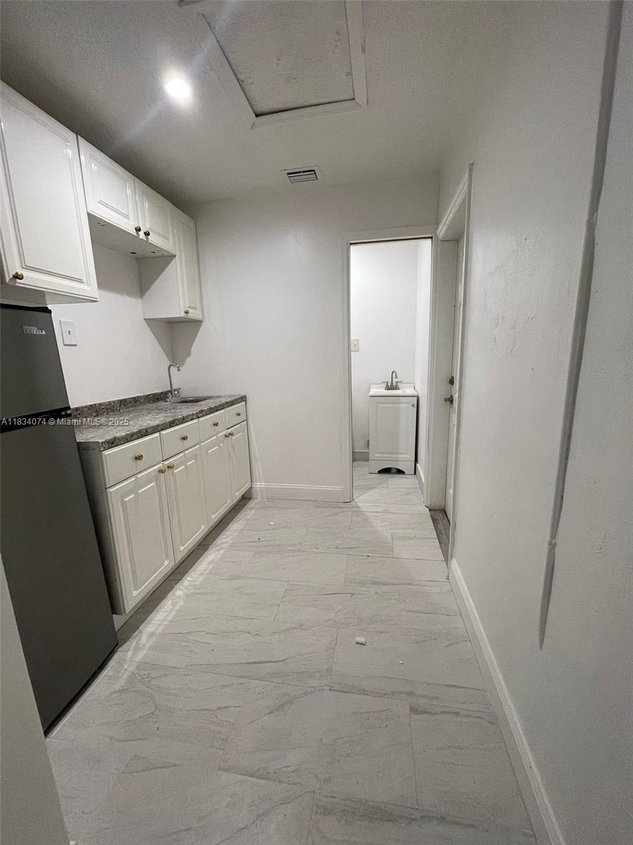 Welcome to this charming studio w/separate bedroom and private entrance in Tamarac, FL, offering a cozy living space that perfectly blends comfort and convenience. Studio unit features an open layout, connecting a modern kitchenette inviting atmosphere. Features include a generously sized bed rm, ceiling fan and a large closet. The updated bathroom boasts a walk-in shower, complemented by clean, modern finishes throughout. You'll appreciate the added security of a private entrance. Internet, electricity, heat, water, trash service, and yard maintenance are all included in the rent. Enjoy the convenience of a dedicated parking spot and central heating and cooling for year-round comfort. Don’t miss out on this exceptional opportunity,! 55+ Community!