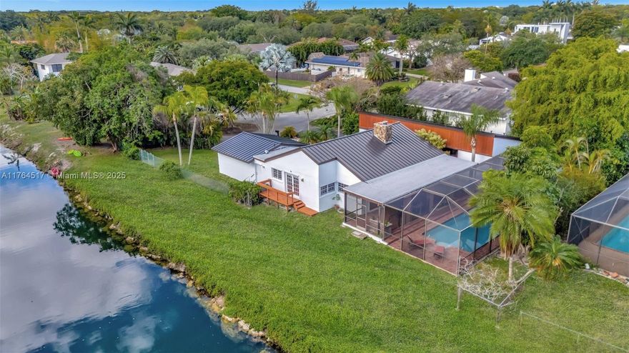 Rare Palmetto Bay Waterfront Home w/great view & screened pool on oversized corner cul-de-sac lot w/ 13 ft elevation. Bring your small boat/jet ski. Close to major shopping centers, parks, top-rated schools, cafes. Brand New Metal Roof 2025, Tall Ceilings, Dual Sinks in Primary En-suite bathroom, walk in closet. Lovely wood beam ceilings, two sided fireplace, large rooms, bright floor plan. Italian tile in 2nd bath. Covered patio is perfect for entertaining, large laundry room, lots of yard w/fence for your pets. 2 A/C units 2018,2019, Newer Appliances, All Copper and PVC Plumbing. 2 water heaters. Portable generator w/transfer switch. No HOA, Survey available, Compare to similar size home at 17640 SW 85th Ave, fully renovated closed $1,950m. Near excellent private schools.
