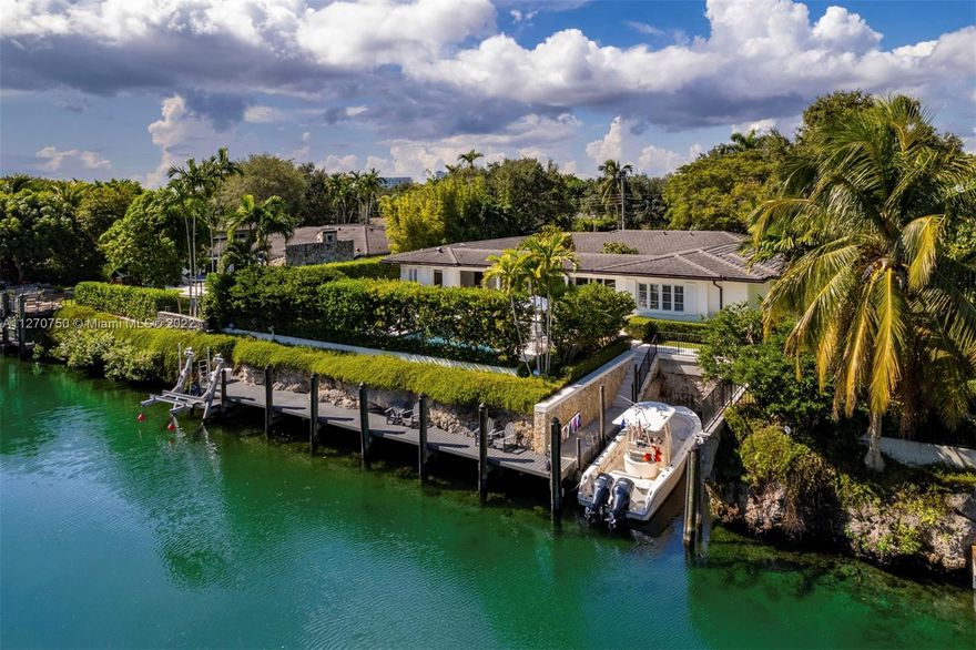 This beautiful contemporary 5,303 Sq. Ft. home with 5 bedrooms and 5.5 bathrooms was designed around spectacular outdoor areas showcasing 85 Ft of waterfront and making this home absolutely perfect for entertaining. A gorgeous great room includes the formal living and dining areas and its open concept design and sliding glass doors offer  views of the sparkling pool, covered terrace and spacious deck with a summer kitchen. The chef's kitchen opens to the family room and it features a wet bar and mystery white marble countertops and comfortable eat-in island. The main suite has custom-designed walk-in closets and a luminous bathroom with double vanities and frameless shower.  An impeccably designed and peaceful retreat close to restaurants, shops, parks and a selection of premier schools.