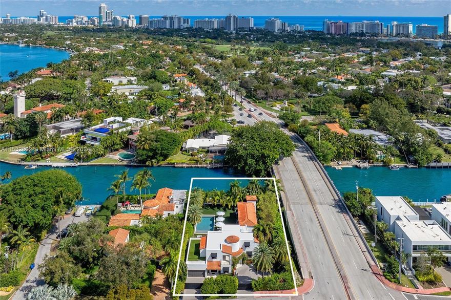 Dive into bliss at 1221 W 48th Street nestled on 100 FT of waterfront! Fully-renovated, $350k+ in upgrades, move-in ready & can be fully turnkey. Modern Mediterranean villa boasts 5 beds/5.5 baths + an office. Oak floors, arched doorways & windows unveil water views. Gather by the fireplace or entertain in the TV lounge w/ a built-in bar, ice maker, fridge & sink. Chef's kitchen features Miele appliances & marble countertops. Primary suite includes dual walk-in closets, reading nook, dual vanities & oversized soaking tub. French doors blur the lines between interior & exterior spaces. Auto-blinds offer privacy & light control. Fire up the cabana BBQ w/ ice maker or play on the pro putting green. Outdoor cabana w/ shower. 2-car garage. New dock w/ shore power can accommodate a 70 FT yacht.