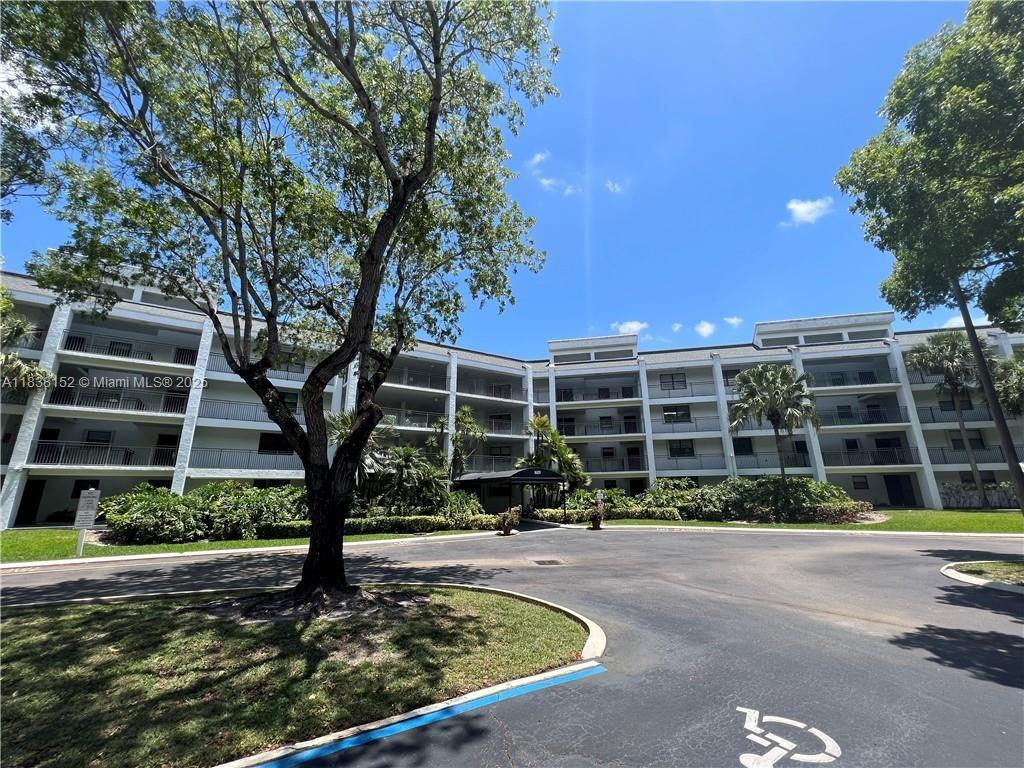 Gorgeous unit with Golf and Lake view and more, completely remodeled featuring 2 bedrooms / 2 baths, elegant ceramic tile floors throughout the entire property, both bathrooms with beautiful rock finishes on vanities and in showers, stainless steel appliances, rock finishes in entrance of kitchen, gorgeous backsplash, granite counter top, lots of cabinets space, bedrooms are very spacious, master bedroom has 2 closets (1 walk in), kitchen opened to dining/living room area, a charming golf and lake view from balcony and master bedroom, washer and dryer in the unit, screened rear balcony, lots of closets for storage and more!!! ALL IMPACT EXCEPT SLIDING DOOR!
