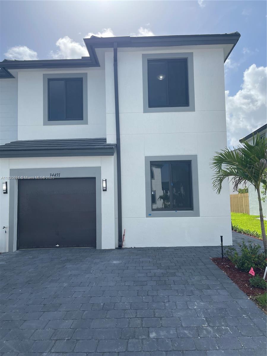 Nestled in the Century Park Square community a new private development in Florida City across from Robert is Here. This brand-new 2-story townhouse offers 4 bedrooms and 3 bathrooms with modern finishes and abundant natural light. One bedroom and a full bath on the first floor provide flexible living space for guests, multigenerational families or a home office. Tile flooring extends throughout the home for easy maintenance and a sleek look. Large windows in every room flood the interior with sunshine, making the unit feel bright and airy. The open kitchen is designed for convenience, featuring plenty of cabinetry and counter space. Additional highlights include a one-car garage and a fully fenced backyard – perfect for privacy and outdoor relaxation.