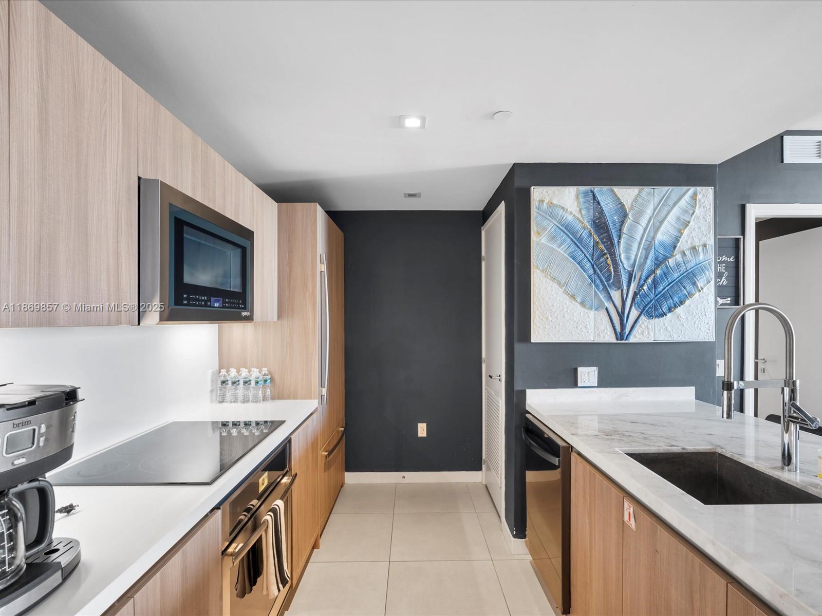Experience luxury living with stunning water views in this modern condo at Tiffany House, just a block from the beach and Intracoastal. Boasting nearly 1,300 sqft and built in 2018, this unit features high-end Jenn-Air appliances, quartz countertops, and floor-to-ceiling windows with remote blackout shades. The master suite offers a marble shower, spa tub, and sunset views. Enjoy access to three pools, including a rooftop pool and bar, plus amenities like a gym, sauna, and theater room. This rental includes two valet parking spaces.