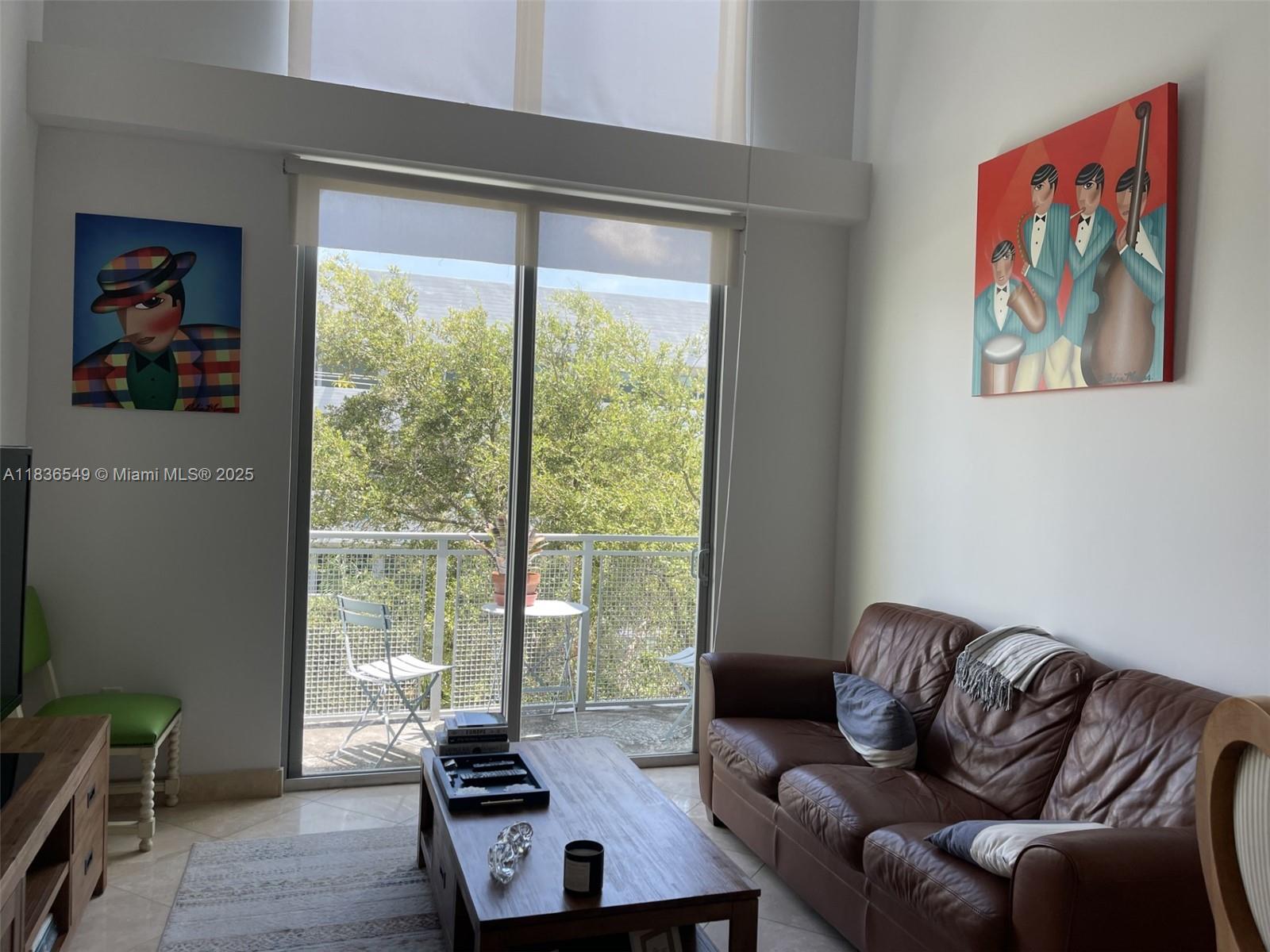 Experience the best of Coconut Grove living in this stunning 2-story penthouse loft, offering 1 bedroom, 1.5 baths, and soaring double-height ceilings in the living area. This bright and spacious residence features travertine marble floors and floor-to-ceiling impact glass windows that flood the space with natural light. The open kitchen is outfitted with granite countertops and stainless steel appliances, perfect for entertaining. Enjoy serene garden views from your private balcony on a quiet side street. The open loft-style bedroom upstairs includes ample closet space and a private full bath, while a convenient half bath and in-unit washer/dryer complete the main level. Enjoy amenities like the private pool, entertainment lounge, fully equipped gym, and secure building access.