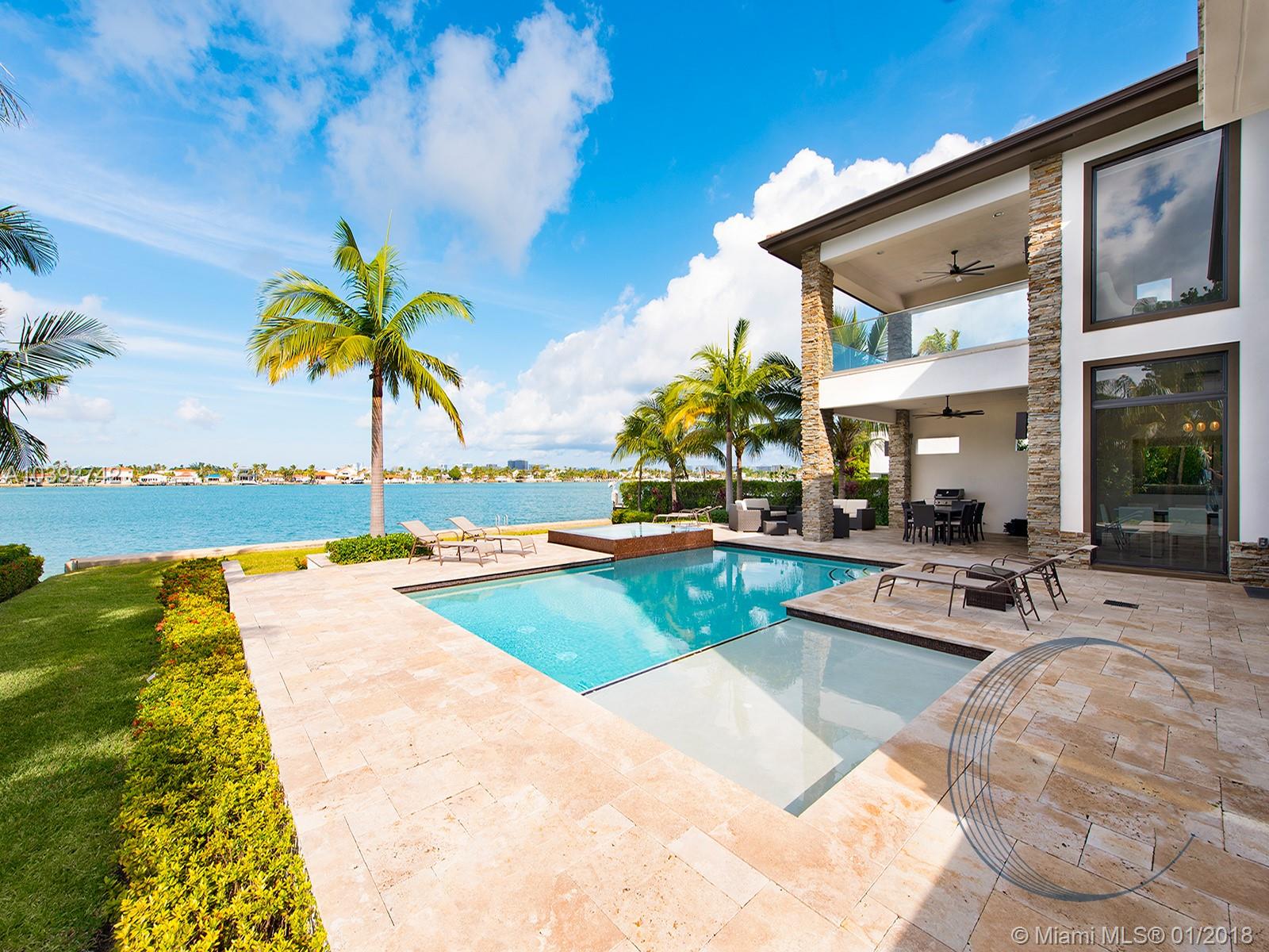 Beautiful 2-story Biscayne Point residence with 4 bedrooms, 4.5 bathrooms on 75 ft of water frontage. Floor-to-ceiling glass highlights the expansive great room, accented by a 2 story stone wall, ethanol fireplace. Gourmet kitchen features teak cabinets, quartz, high end stainless steel appliances with a chef's gas range and walk-in pantry. First floor also consists of a 2nd master suite, media room, and formal dining. Second floor features master suite with private terrace overlooking the bay, as well as office and two full size bedrooms.