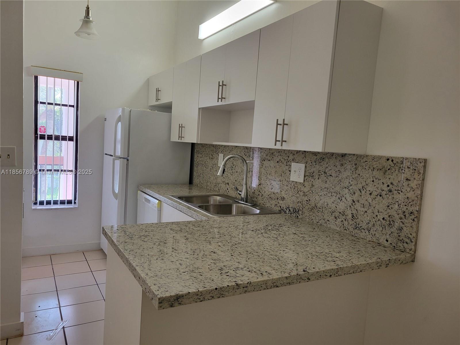 Beautiful 2nd floor condo - Ready to Move In! this updated condo is vacant and ready for you to call home! Featuring a brand ne kitchen with granite countertops and stylish new bathrooms, you'll enjoy comfort all year round! The unit has been freshly painted, boasts all tile flooring, and comes with a washer & dryer inside for your convenience. You'll have 2 parking spaces - 1 assigned and 1 visitor with a sticker - plus unbeatable proximity to shopping spots like Walmart, BJ's, Target, DD's, Publix, restaurants, gyms, and excellent schools. SORRY, NO PETS. Easy to Show! Schedule your visit today!
