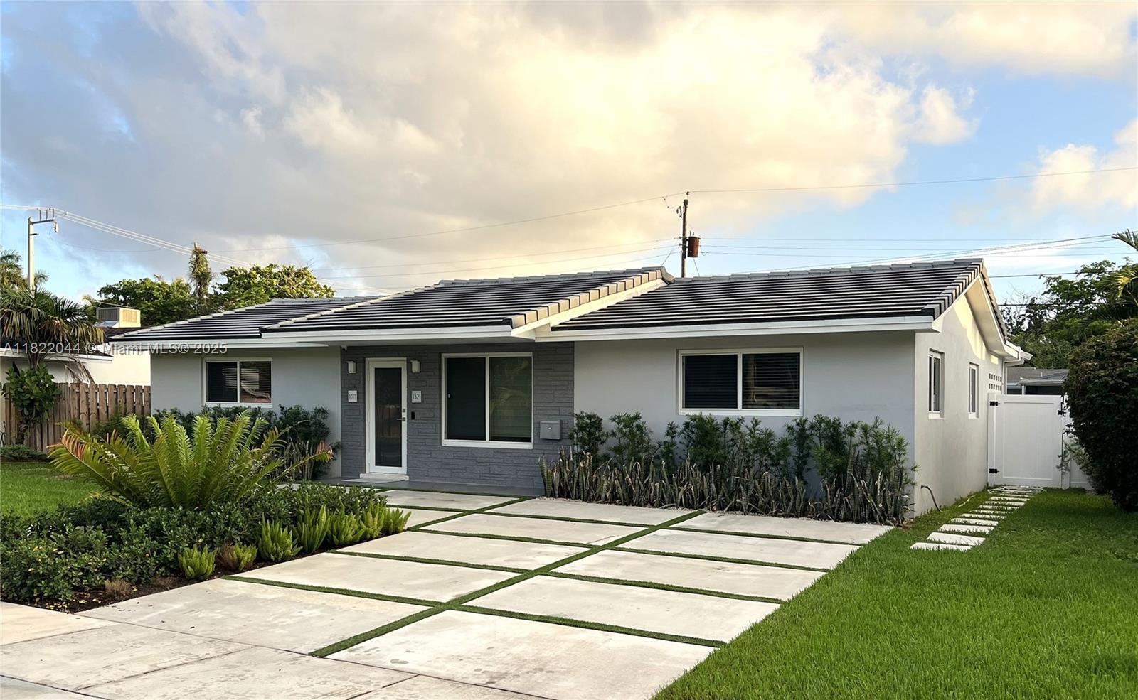 Stunning and spacious 3/2 home in the prestigious Hollywood Lakes area with a spectacular backyard oasis featuring a contemporary pool/spa, covered patio with misting system, impeccable landscaping and more! Fully renovated, with 100% new plumbing system, floors, kitchen, bathrooms, driveway, impact doors and windows -- all done with permits. Laundry room inside and storage room outside. A truly unique home, virtually re-built completely and tastefully with the highest quality finishes. Equipped with Ring, Nest, etc.. Located minutes from the beach, 2 public golf courses and downtown Hollywood. Also listed for rent for $5,600/Month (MLS # A11823628)