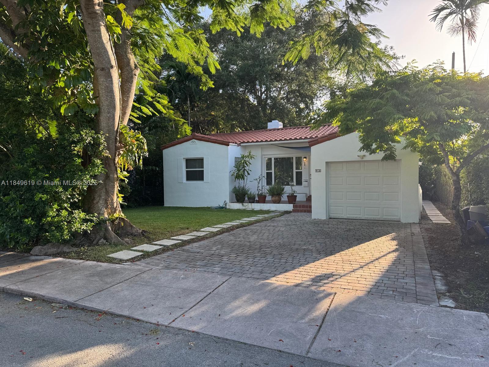 This special home was built in 1946 and features many architectural details. It is surrounded by lush vegetation on a 5,350 sq ft lot, creating an oasis-like atmosphere. The home includes 2 bedrooms/ 2 baths, along with a one-car garage, air conditioned, ready to use as an office. Impact windows and doors, an updated kitchen, hardwood floors throughout, fireplace. The beautiful Florida room has windows that overlook the gorgeous garden, which is alive with the songs of many birds. Located within walking distance of downtown shopping, the Coral Gables Country Club golf course, and tennis courts, also close to the Biltmore Hotel. This is a fantastic location in an A+ neighborhood, ideal for public elementary and middle schools. This home is a MOVE -IN ready!