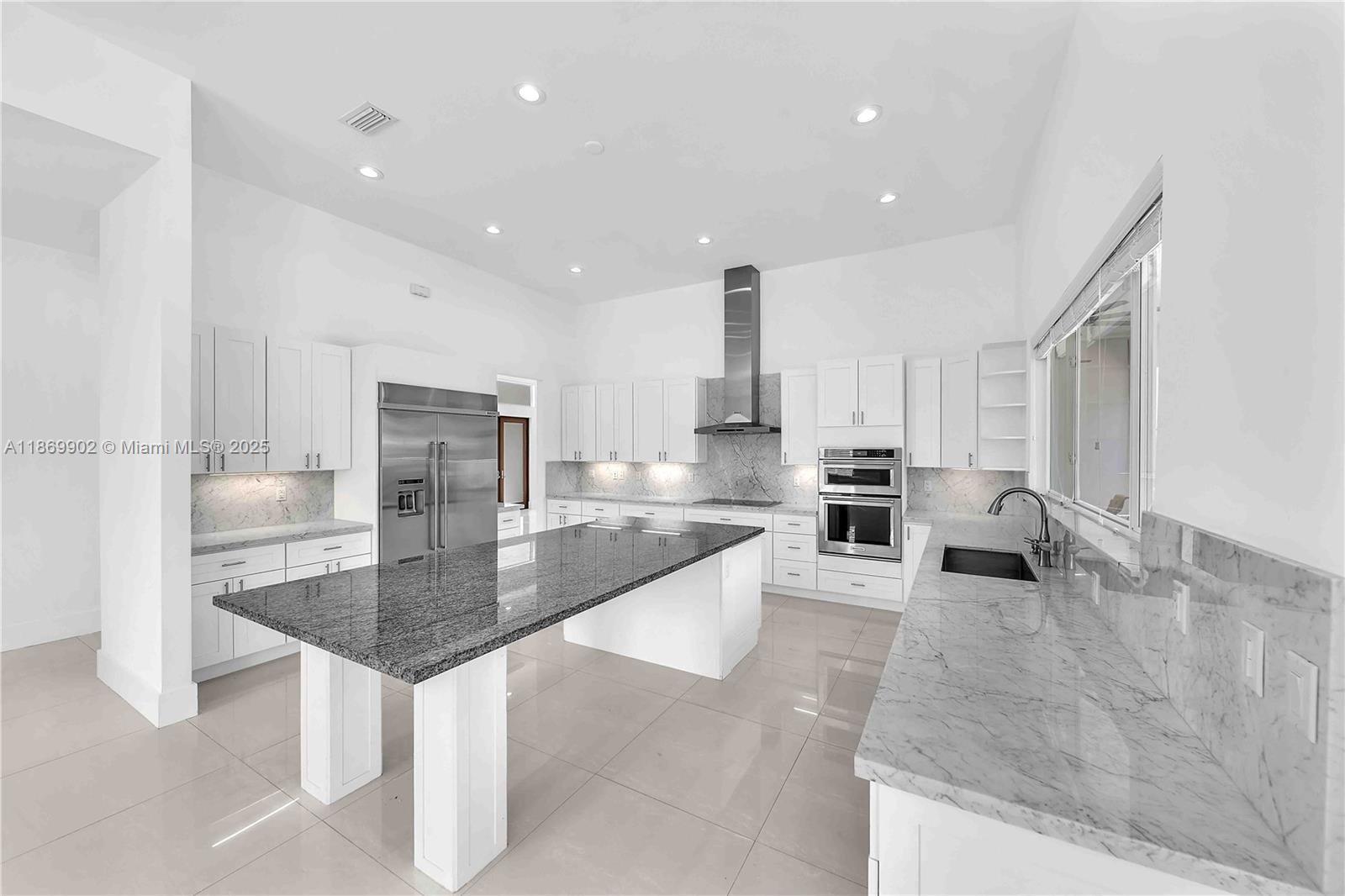 Built in 2019 by a contractor. This beautiful 4,500+ SQFT, 4-BD, 5-BA home sits on a sizable 18k+ SF lot. The residence showcases beautiful curb appeal on quiet block. Walk into 13 foot ceilings with custom oversize 8 ft doors. An eat-in kitchen offering marble & granite countertops, stainless-steel appliances, built-in island/table doubles as seating, & walk-in pantry for extra storage. The open layout seamlessly connects the kitchen, & family rooms with sliding doors to the patio, merging indoor and outdoor entertainment areas. Enjoy your backyard all year round, covered patio, & plenty of room to entertain guests. Additional features include an irrigation with well water, Generator, impact, 2-car garage, pre-wired for security cameras & surround sound.