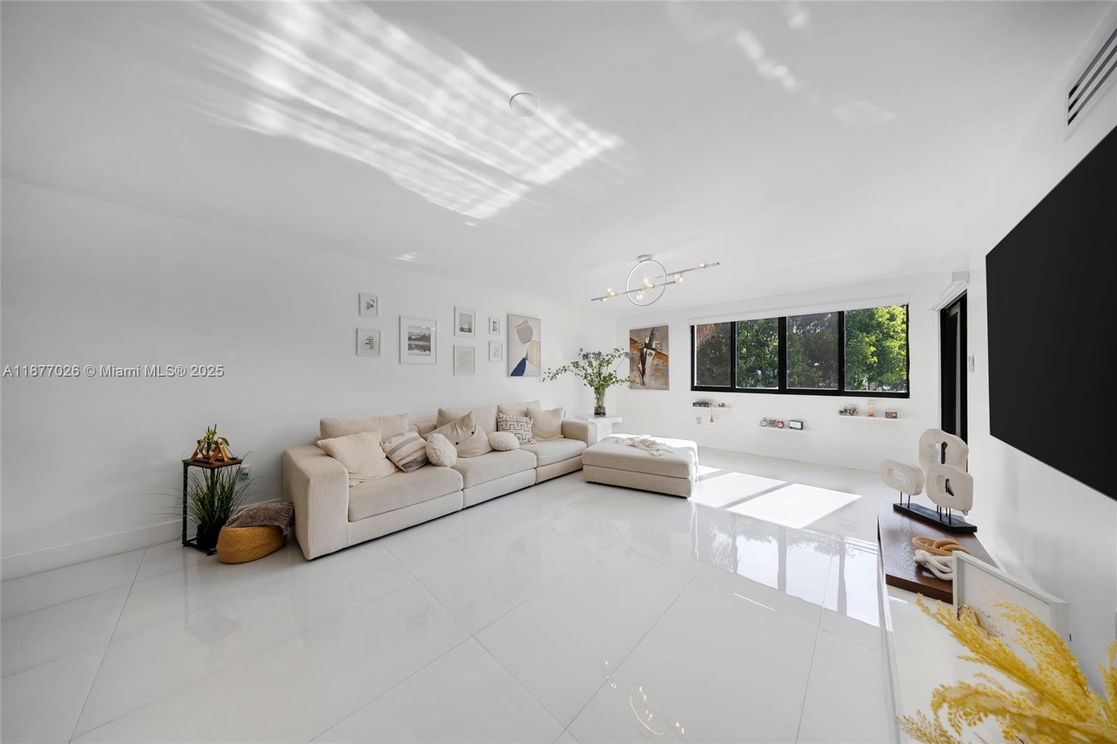 Stunning remodeled 2/1 in Fontainebleau Park West! Kitchen features exotic granite with onyx & quartz, complemented by new doors, custom closets, designer light fixtures, motorized curtains & impact windows. Smart living with keyless passcode entry. Bright open layout with tile floors and private balcony. In-unit washer and dryer. Community pool & green areas. Central location near Dolphin Mall, restaurants, schools & expressways. Truly move-in ready with modern finishes!