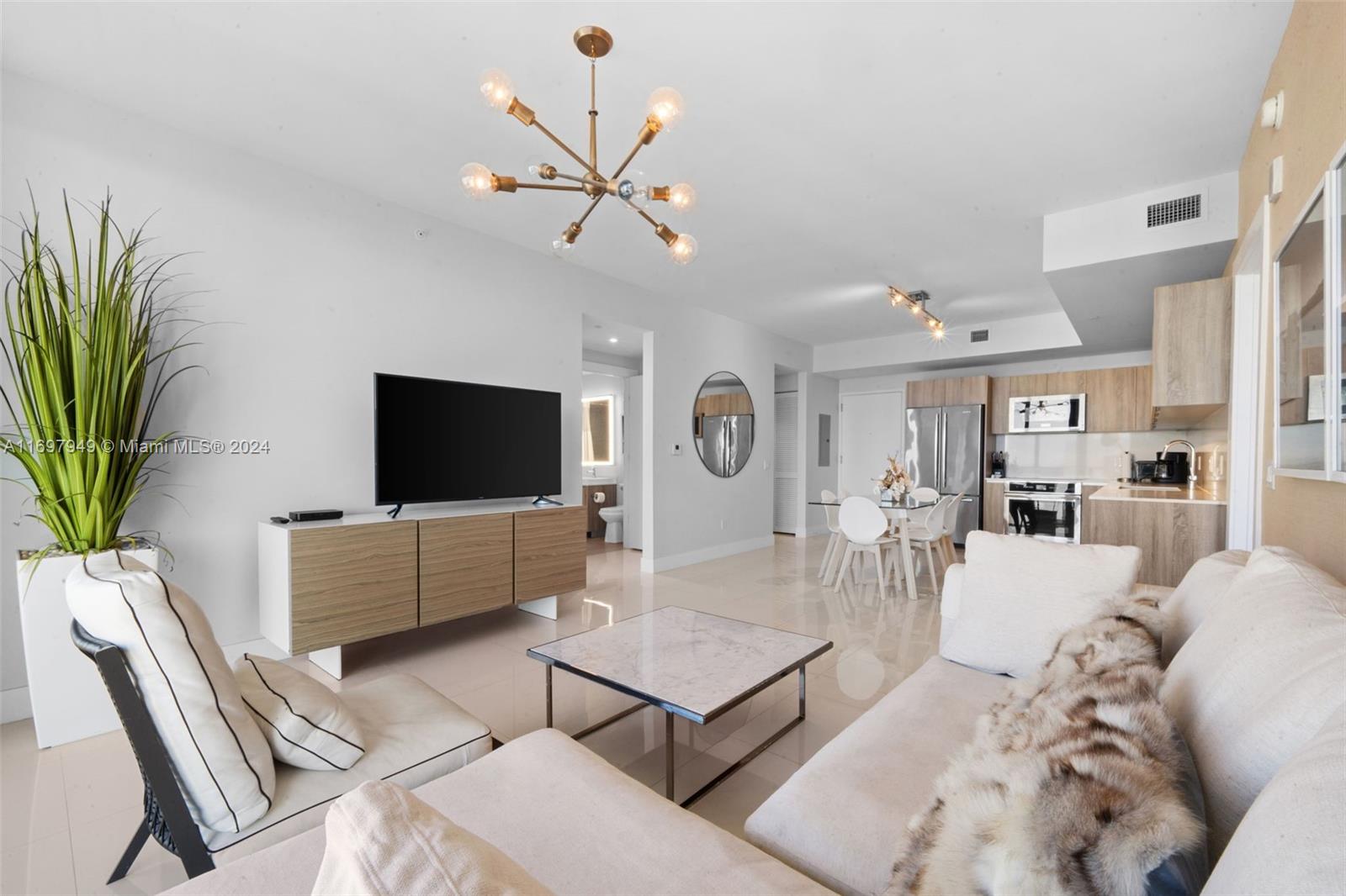 This exquisite 2-bedroom + den home, furnished by Steven G., is a standout in Aventura Park Square—one of few new buildings in the neighborhood. Perfect for modern living or as an investment, it allows short term rentals in a high-demand area, making it a rare and lucrative opportunity.
Enjoy a sunlit, west-facing great room with floor-to-ceiling windows and a spacious balcony. The sleek kitchen offers ample counter space and storage, while the primary suite features a spa-like bathroom and dual closets. A second bedroom with balcony access, a cozy den, second bathroom, and in-unit washer/dryer complete this turnkey gem.
Aventura Park Square offers unbeatable convenience with premier dining, fitness, and salons steps away. Amenities include a pool, gym, BBQ area, and 24/7 concierge.