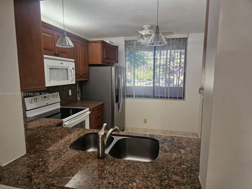 Photo of 8592 W Sunrise Blvd #209, Plantation, FL 33322 (MLS # A11941519)