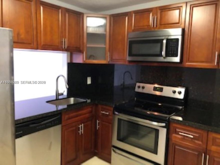 Beautiful corner unit, flooded with light in building H. Remodeled kitchen with granite counter, open to the dining and living area. Top of the line stainless steel appliances. Laminated wood floors installed throughout. Great bathroom with modern cabinet, tub/toilet & floors. Impact door and windows throughout, make this unit very quiet and being on a first floor easily accessible.  The building is right across from the pool/gym, BBQ area, & canal. Plenty of parking for your cars. Professionally managed building. The University of Miami, Dadeland Mall, Trader Joe's, Starbucks, Don Pan, TJ Maxx, restaurants & grocery stores are a few minutes away!