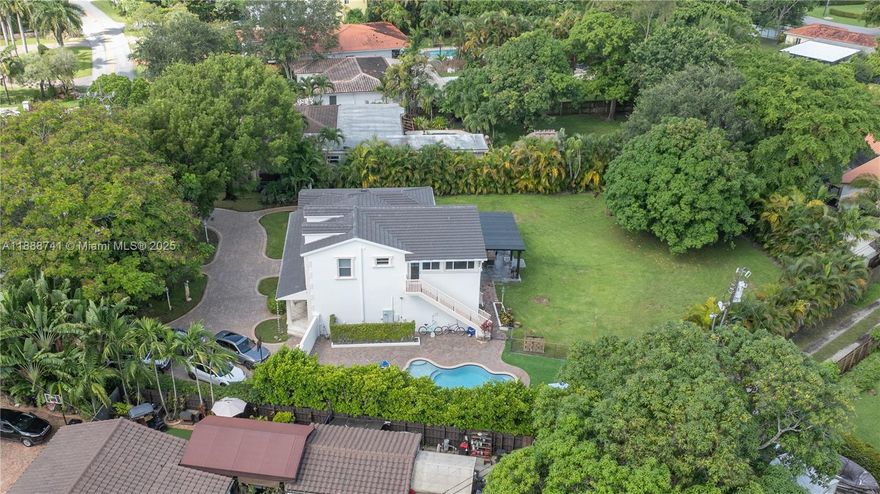 Beautifully renovated home sitting on a oversize lot in the heart of small Town Miami Springs in the premium area of the golf course. Discover a chef's kitchen with stainless steel appliances & white cabinetry and leading to a backyard featuring custom patio with fence and alley access perfect for RV/Boat, an in-ground pool, mango tree and is the perfect oasis for outdoor entertainment. Floors are ceramic, porcelain tile and wood. Other features include: front porch, hurricane impact windows and doors, newer roof in 2023, laundry room, exercise room,  california closets, high ceilings. Located near aquatic center, playhouse, tennis court. Easy Access to highways, 30 mins to Beach, 10 mins to Miami Airport. This property is immaculate, well-cared for, and ready for new owners. Welcome home!