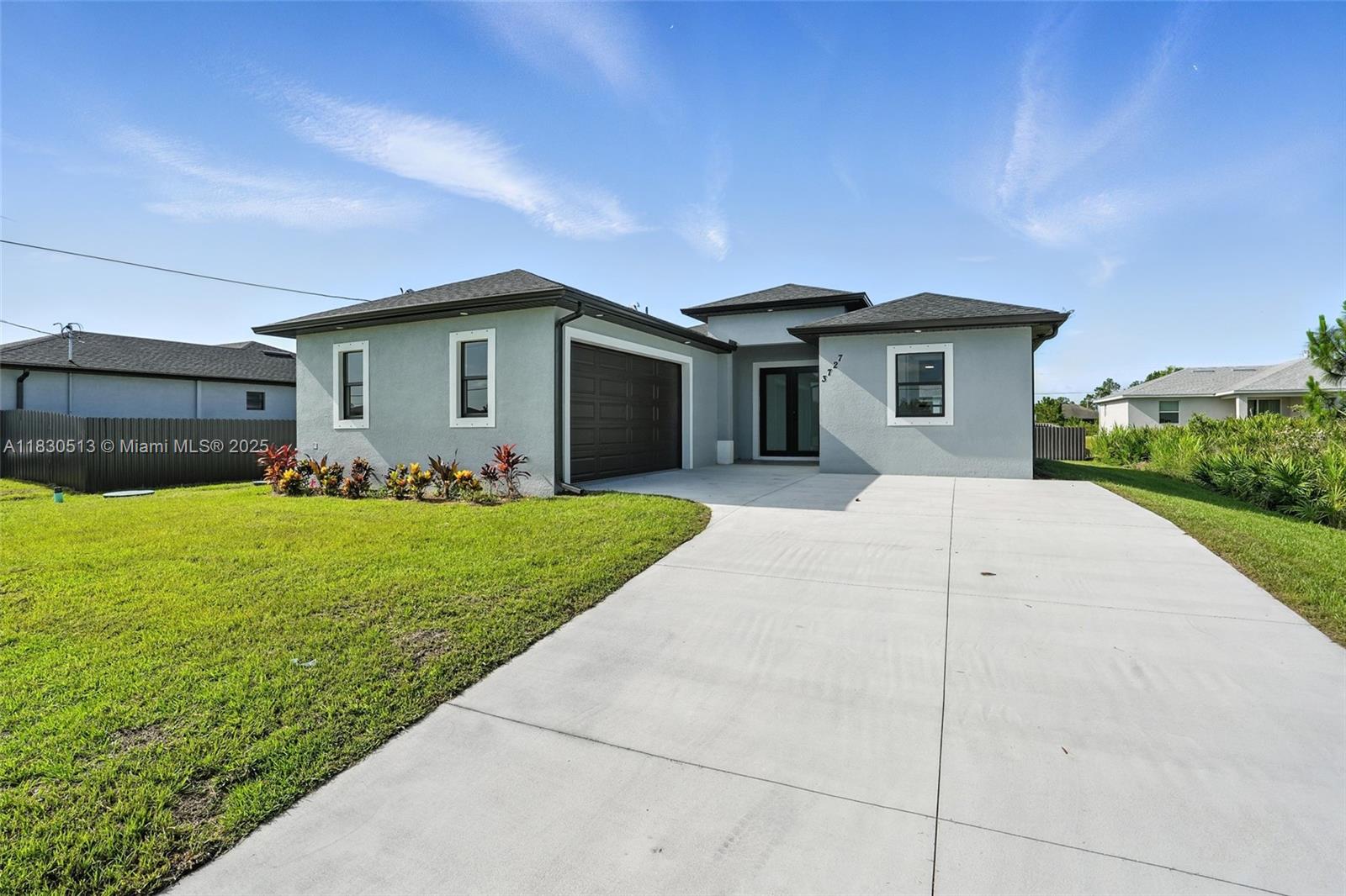 Gorgeous new home in Lehigh Acres! No HOA and a great price. This move-in-ready property offers a spacious open layout with elegant tile flooring, modern light fixtures, and a sleek kitchen featuring quartz countertops and plenty of cabinet space—perfect for cooking and entertaining. With 3 bedrooms, 2 bathrooms, nearly 1,400 sqft, a 2-car garage, and a dedicated laundry room, it has everything you need. The split floor plan provides privacy, and the primary suite includes a large bathroom with double vanity and walk-in shower. Enjoy a huge backyard ready for your future pool, garden, or outdoor retreat. Excellent location just minutes from Lee Blvd, with easy access to Fort Myers, RSW Airport, and Hammond Stadium. Don’t miss this fantastic opportunity!