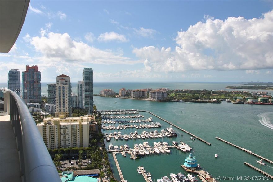 STUNNING flow-thru 3,058 SF condo offers one of the most preferred & largest layouts with majestic bay, ocean, Fisher Island & Downtown Miami views. This soaring 32nd floor residence boasts 3 bedrooms 3.5 bathrooms, a large open kitchen with top-of-the line appliances & granite counters, whitewashed hardwood floors, Sheerweave solar shades, spacious SUNSET & SUNRISE terraces ideal for entertaining, floor-to-ceiling glass windows that extend the vistas from every room plus 5-star resort living from this signature building overlooking the marina.