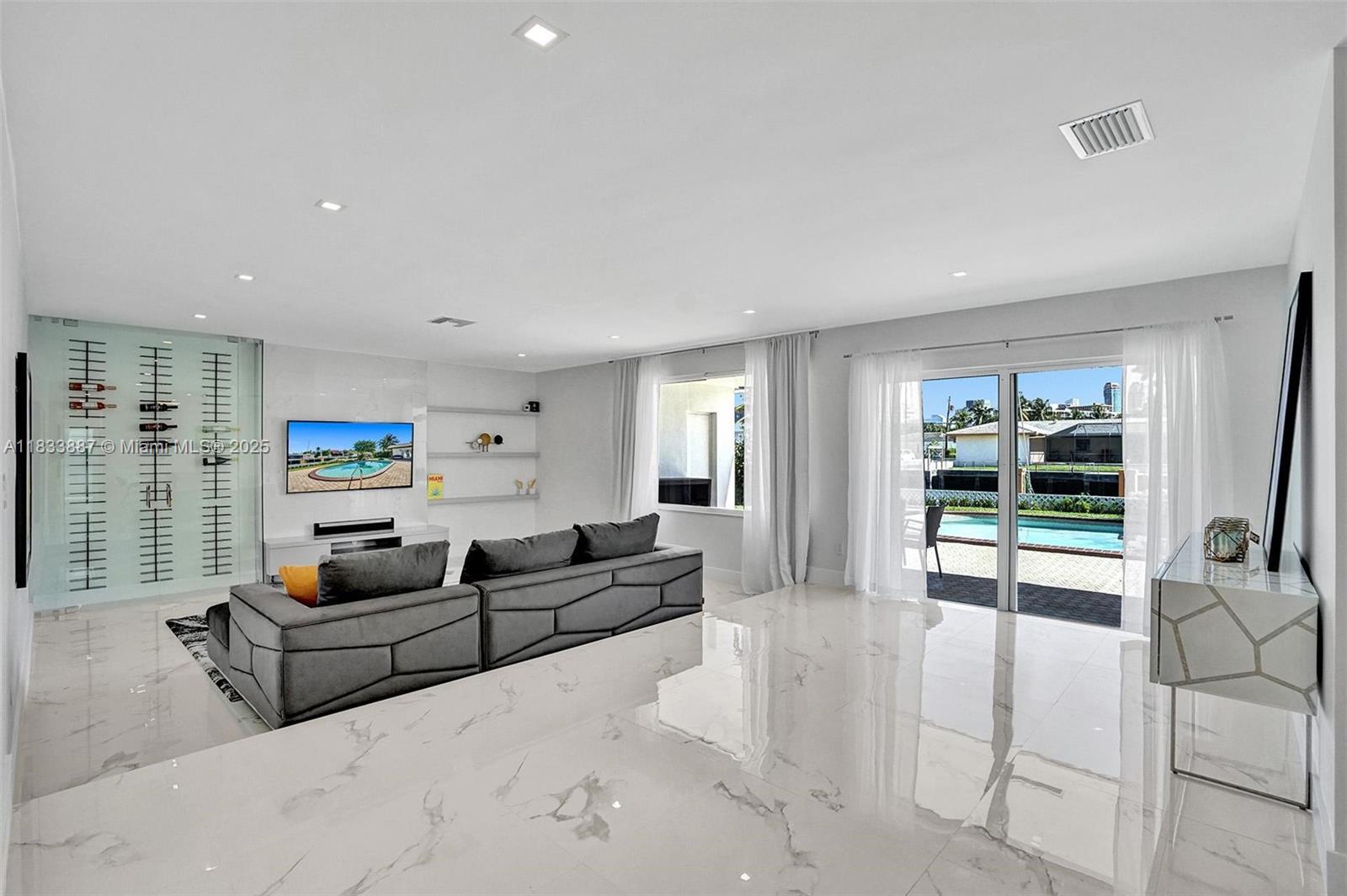 This beautifully renovated 3-bedroom waterfront home is nestled in the exclusive Eastern Shores neighborhood, offering a perfect blend of luxury and convenience. The property features a heated pool, private dock, and a spacious 2-car garage. With modern upgrades throughout, this home provides an open floor plan ideal for both relaxation and entertaining. Located just 10 minutes from the beach and within walking distance to shops and restaurants, this prime location offers the best of Miami living. Whether enjoying the serene water views or taking advantage of the nearby amenities, this property truly has it all.