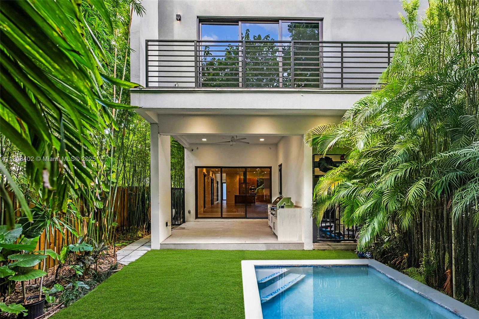 Experience the best of Coconut Grove living in this modern 4-bedroom, 5-bath single-family home, built in 2022 for effortless indoor-outdoor living. Behind a private gate, it offers open spaces, floor-to-ceiling impact glass, and refined finishes throughout. The gourmet kitchen features Italian Pedini cabinetry, Bosch appliances, and quartz countertops. The layout includes a floating staircase, sleek baths, and two A/C units. Step outside to a private pool, summer kitchen, and lush landscaping. Ideally located on a quiet tree-lined street near top schools, parks, restaurants, and marinas. Two-car garage and smart-home features complete this home.