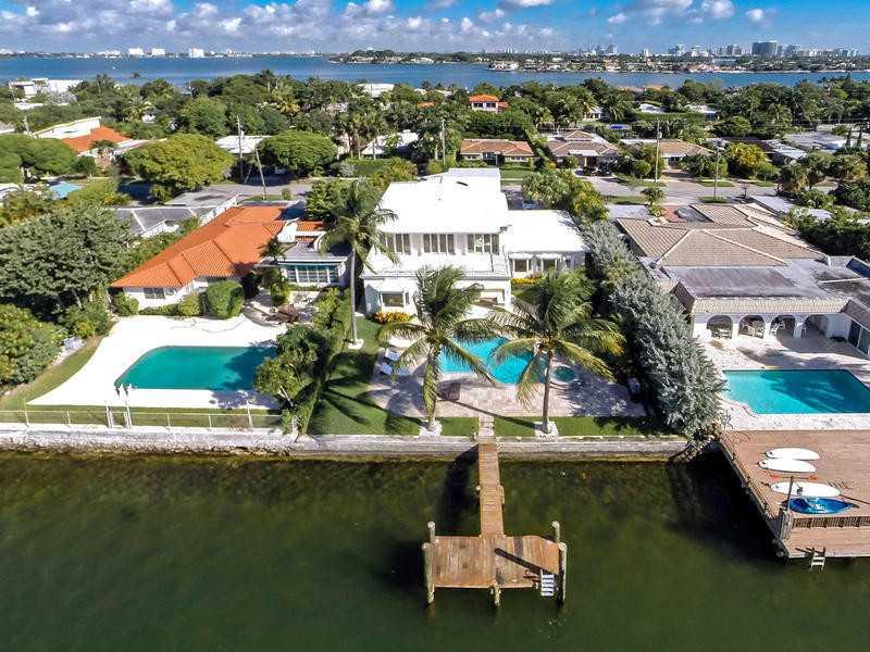 Waterfront 4 bedroom + Den 2 story house in Miami Beach prestigious guard gated Biscayne Point Island. This 4/4 home has over 4,600 sq ft interior space with open floor plan, covered patio overlooking pool, 75 feet of deep water frontage & wide ocean sun set views. Master bed with large private patio. Hurricane windows, high end appliances, generator, grill, 2 car garage, fully furnished*** Move in & enjoy Florida Living at its best!