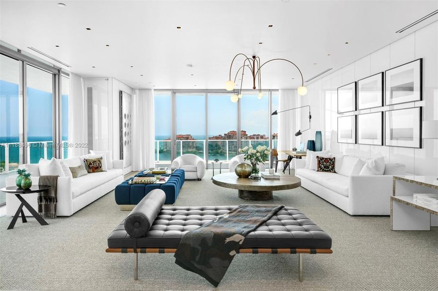 Designed by renowned Luis Bustamante, this renovated residence at the coveted Apogee merges impeccably curated finishes, & a perfectly distributed open floor plan maximizing living areas, space & views through floor-to-ceiling windows & expansive balconies overlooking Biscayne Bay, Fisher Island & the ocean. Indoor/outdoor living collides gracefully w/ walls of glass & an expansive 11’ deep wraparound balcony. Luxurious features include wide plank, stained natural oak wood on floors & wall details throughout, white high gloss lacquered walls throughout the living room, Thasos Marble in all bathroom floors, shower walls & countertops, fully automated smart home w/ surround sound, electric shades & Lutron lighting. Gourmet kitchen w/Calacatta Gold marble & SubZero, Wolf & Miele appliances.