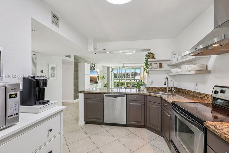 Beautifully updated 2 bed, 2 bath first-floor condo with stunning lake views, featuring tile flooring throughout, quartz countertops, stainless steel appliances. Living room and dining room feature modern built-ins for extra storage. This bright and airy unit is filled with natural light and includes ALL impact windows and patio doors. Both bedrooms are en-suites, with the primary offering a spacious walk-in closet. Enjoy relaxing lake views from your private, enclosed impact-glass patio. The condo has a new A/C and water heater, is extremely well maintained, and is located in a building with reserves that has passed the 40-year inspection. Monthly fee covers water, cable, internet, reserves and much more  All ages welcome, minutes from shopping, restaurants, casino, and Pompano Beach.