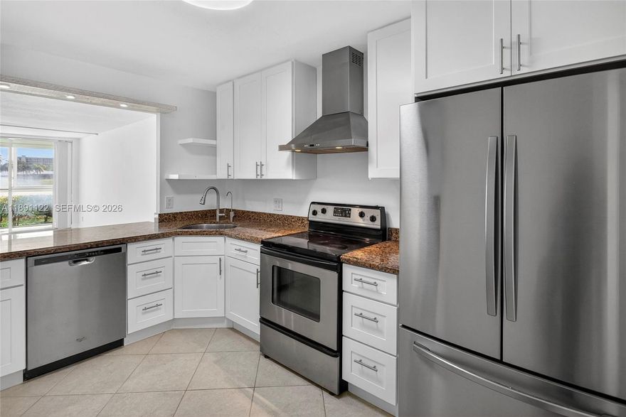 All resonable offers considered. Priced to sell.  Beautifully updated 2 bed, 2 bath first-floor condo. New white kitchen cabinets. All impact windows and doors. Stunning lake views, featuring tile flooring throughout, quartz countertops, stainless steel appliances. Living room and dining room feature modern built-ins for extra storage. This bright & airy unit is filled with natural light. Both bedrooms are en-suites, with the primary offering a spacious walk-in closet. Enjoy relaxing lake views from your private, enclosed impact-glass patio. The condo is extremely well maintained, and is located in a building with reserves that has passed the 40-50 year inspection. Monthly fee covers water, cable, internet, reserves and more.  All ages welcome, minutes from shopping, restaurants, casino, and Pompano Bch. Cats ok. Amazing opportunity.